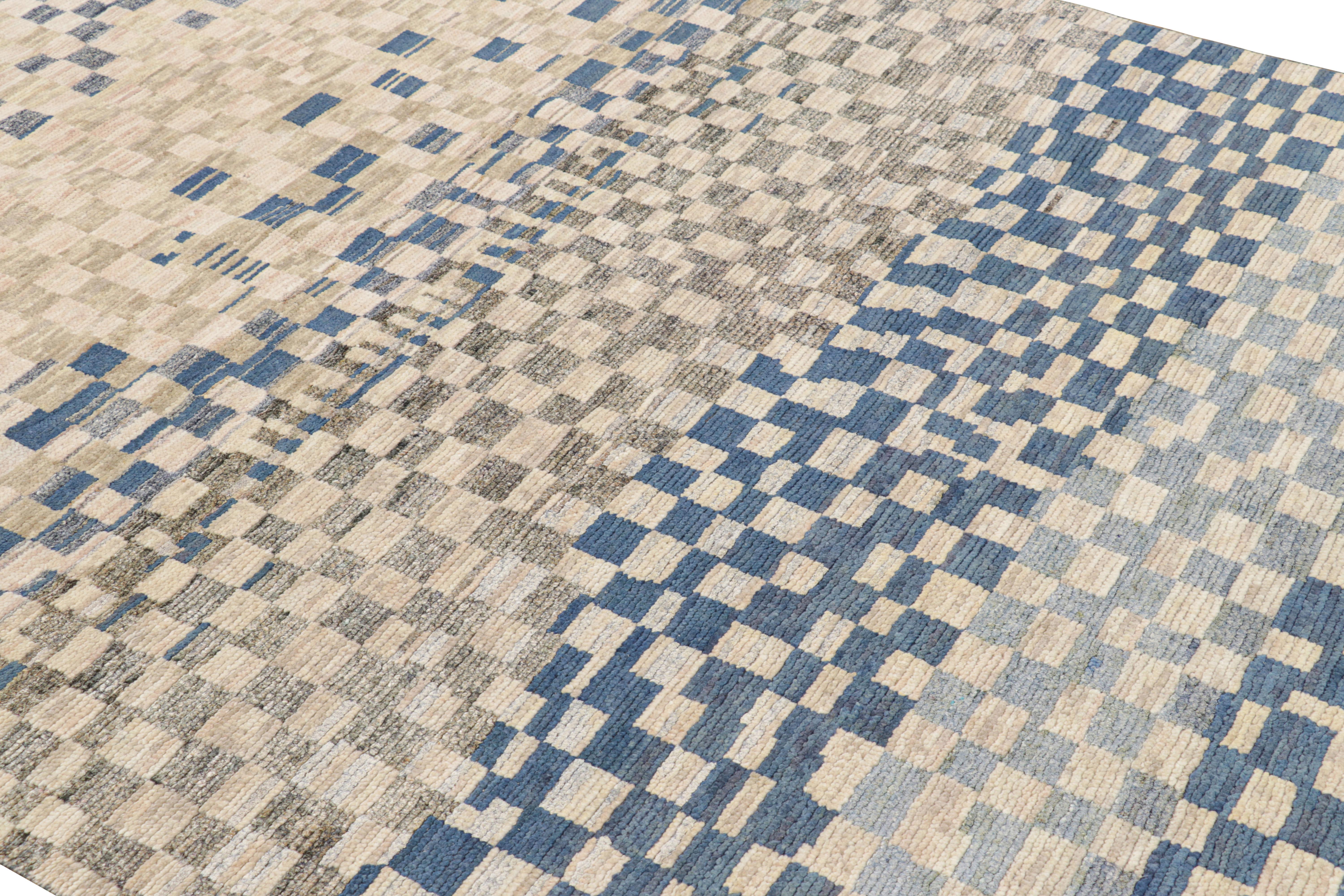 Hand-knotted in wool and silk, this 6x9 contemporary rug from Rug & Kilim features geometric patterns with a modern abstract appearance—drawing on the primitivist Berber tribal designs. 

On the Design: 

A rich, lush pile in blue, gray and beige