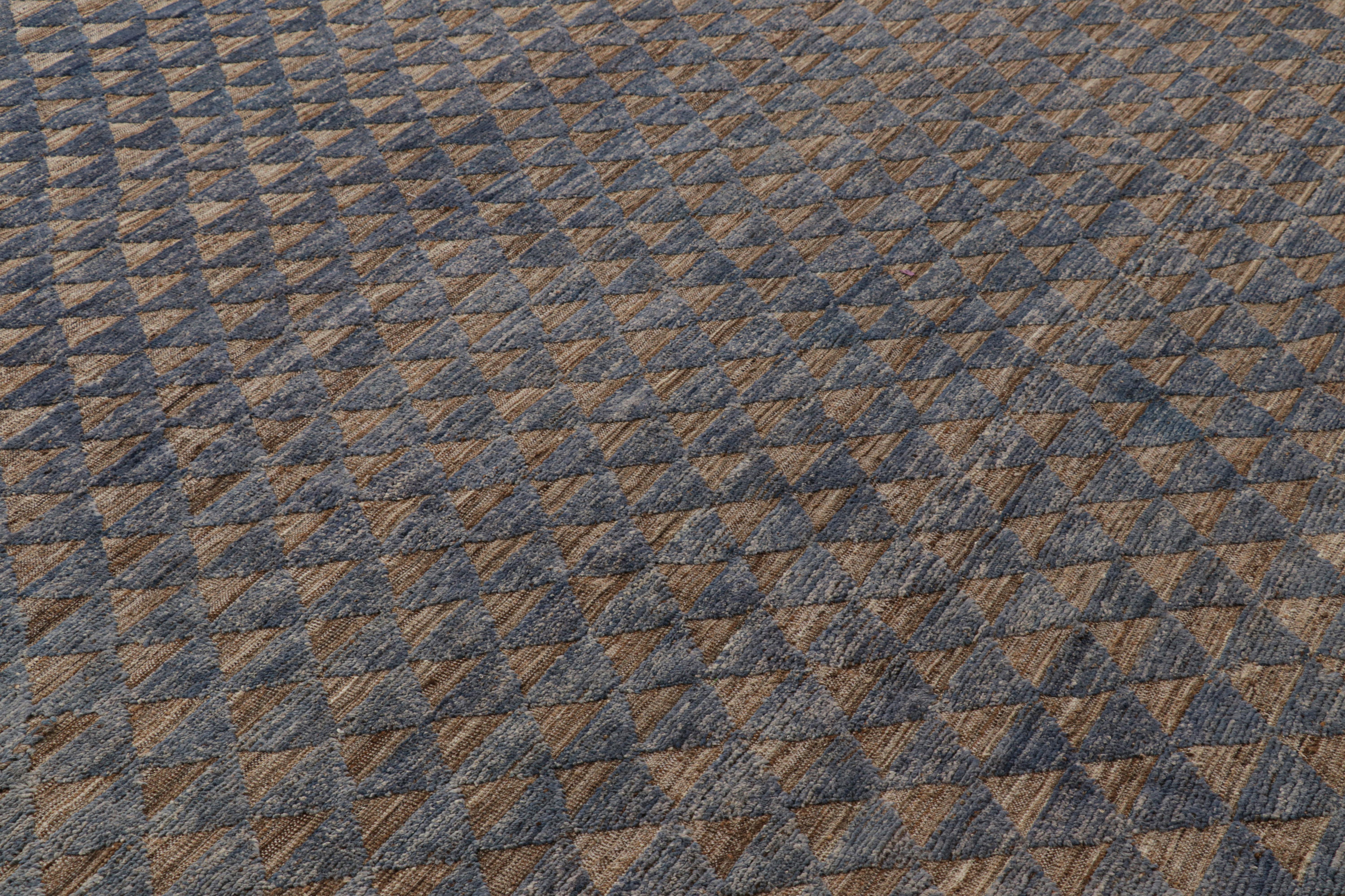 Made with hand-knotted wool, this 9x12 Moroccan rug in blue and brown features a contemporary approach to Berber tribal rugs with a high-low texture married to its geometric patterns.  

On the Design: 

Connoisseurs may admire the blue and brown