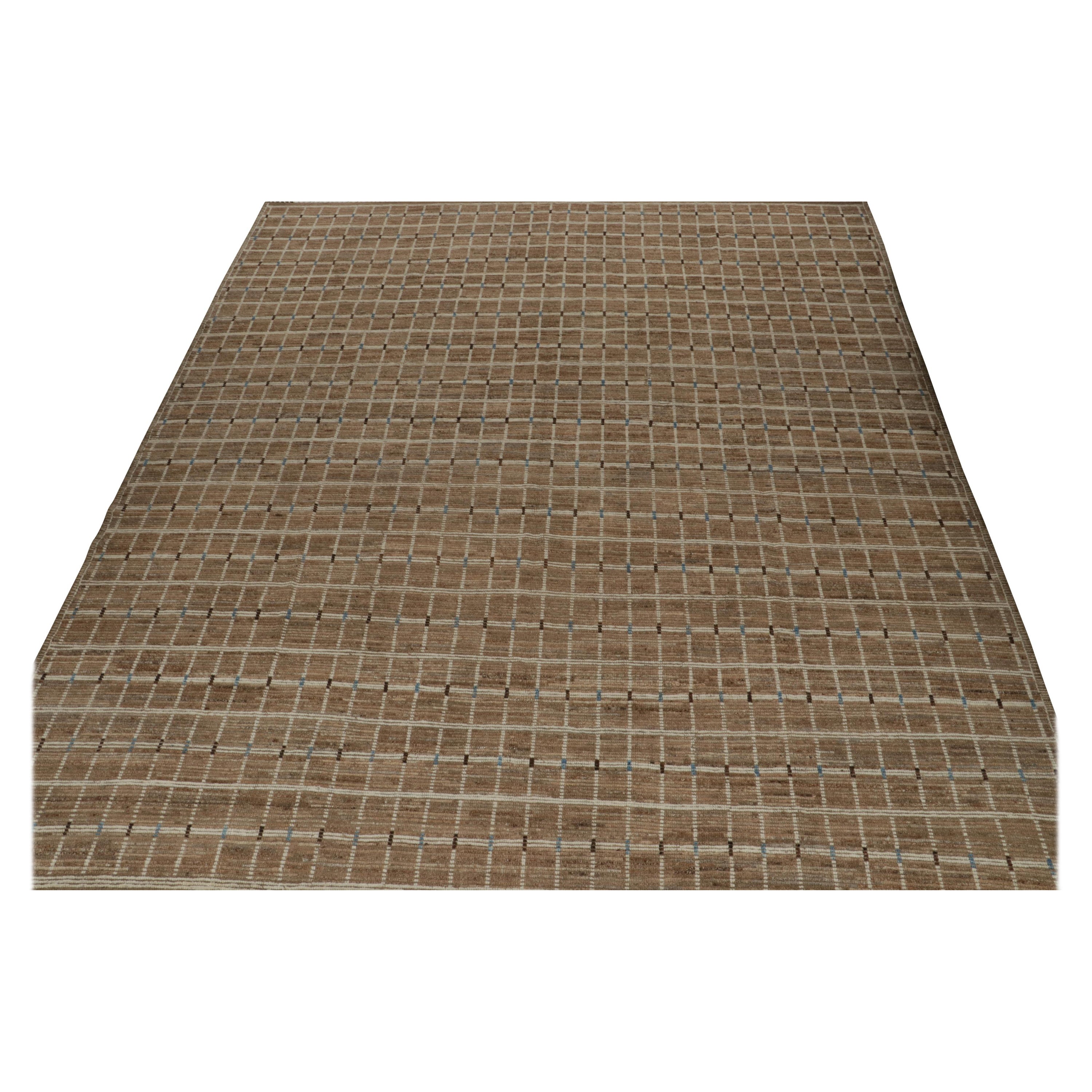 This hand-knotted wool 12x15 rug is a new addition to the Moroccan rug collection by Rug & Kilim. Its design represents our modern take on primitivist Berber styles, and enjoys beige-brown undertones, off-white stripes and blue accents. 

On the