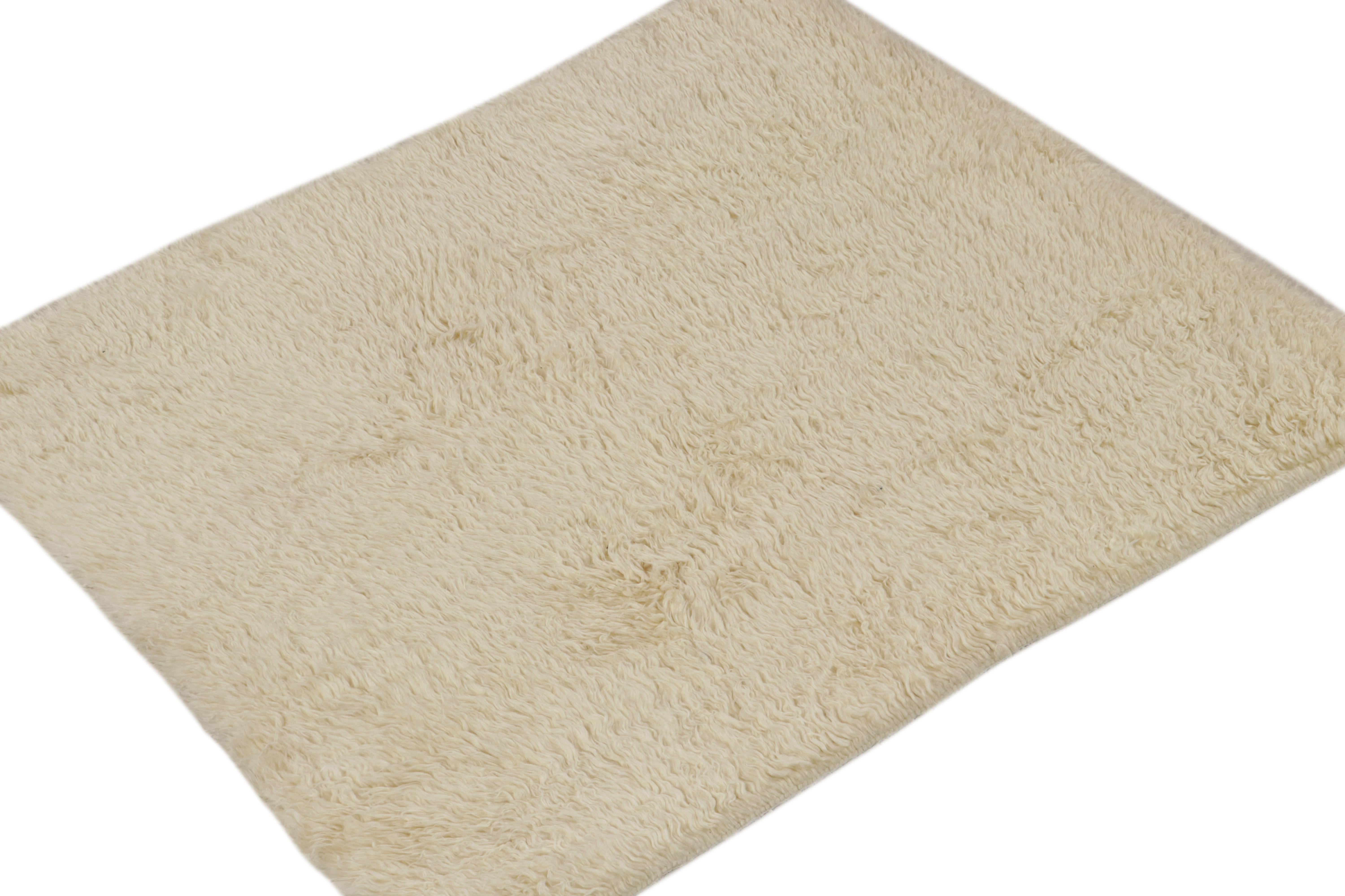 This 4x5 shag rug is a contemporary addition to the Moroccan rug collection by Rug & Kilim.

Further on the Design:

Hand-knotted in wool, this piece enjoys a lush pile and warm cream color in its simple, natural presence. Keen eyes will further