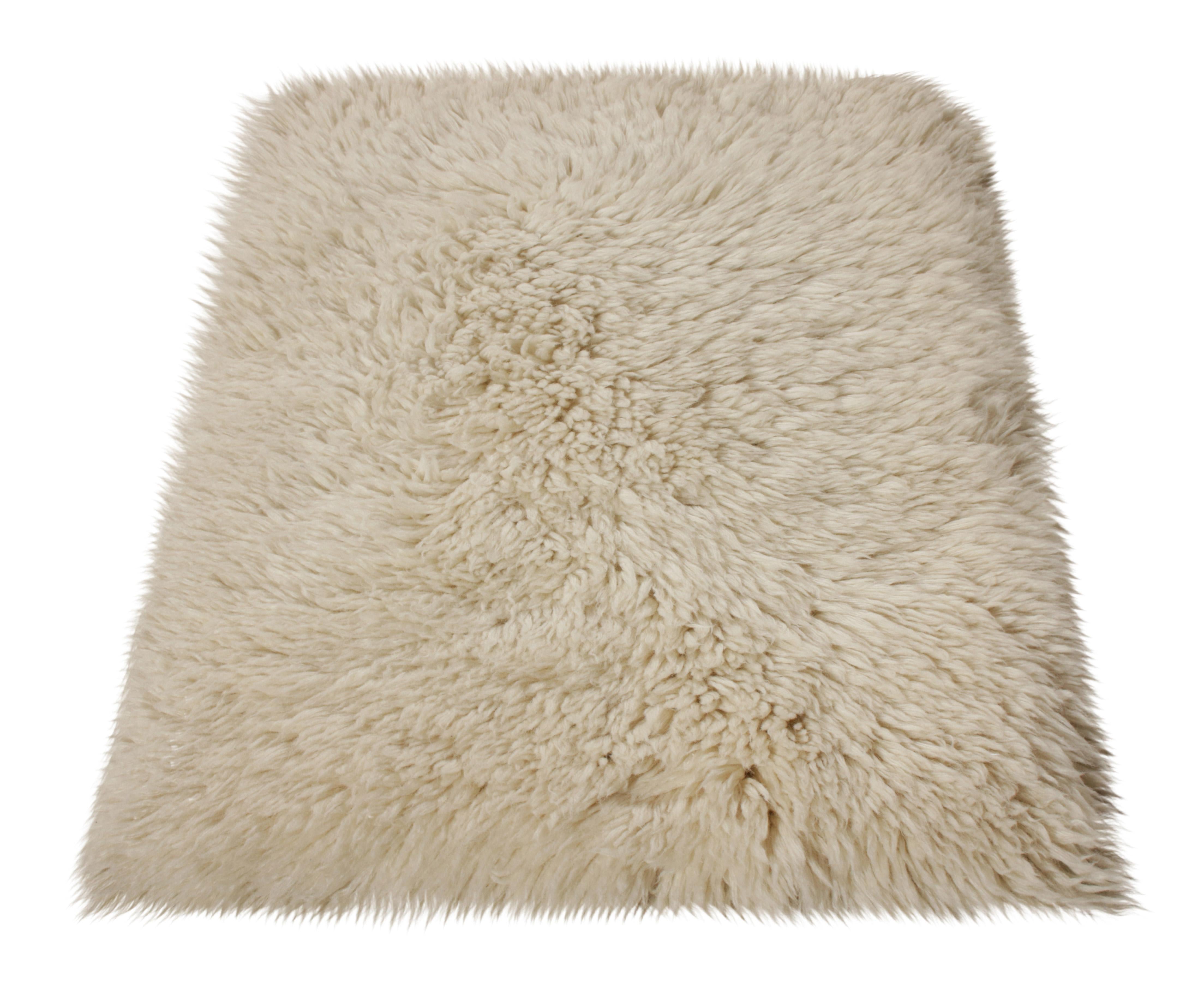 A 2x3 accent rug where Rug & Kilim makes a modern take on the celebrated Moroccan style. Hand knotted in wool, this comfortable contemporary in solid beige-white carries a welcoming personality with a luxurious high pile further complementing the