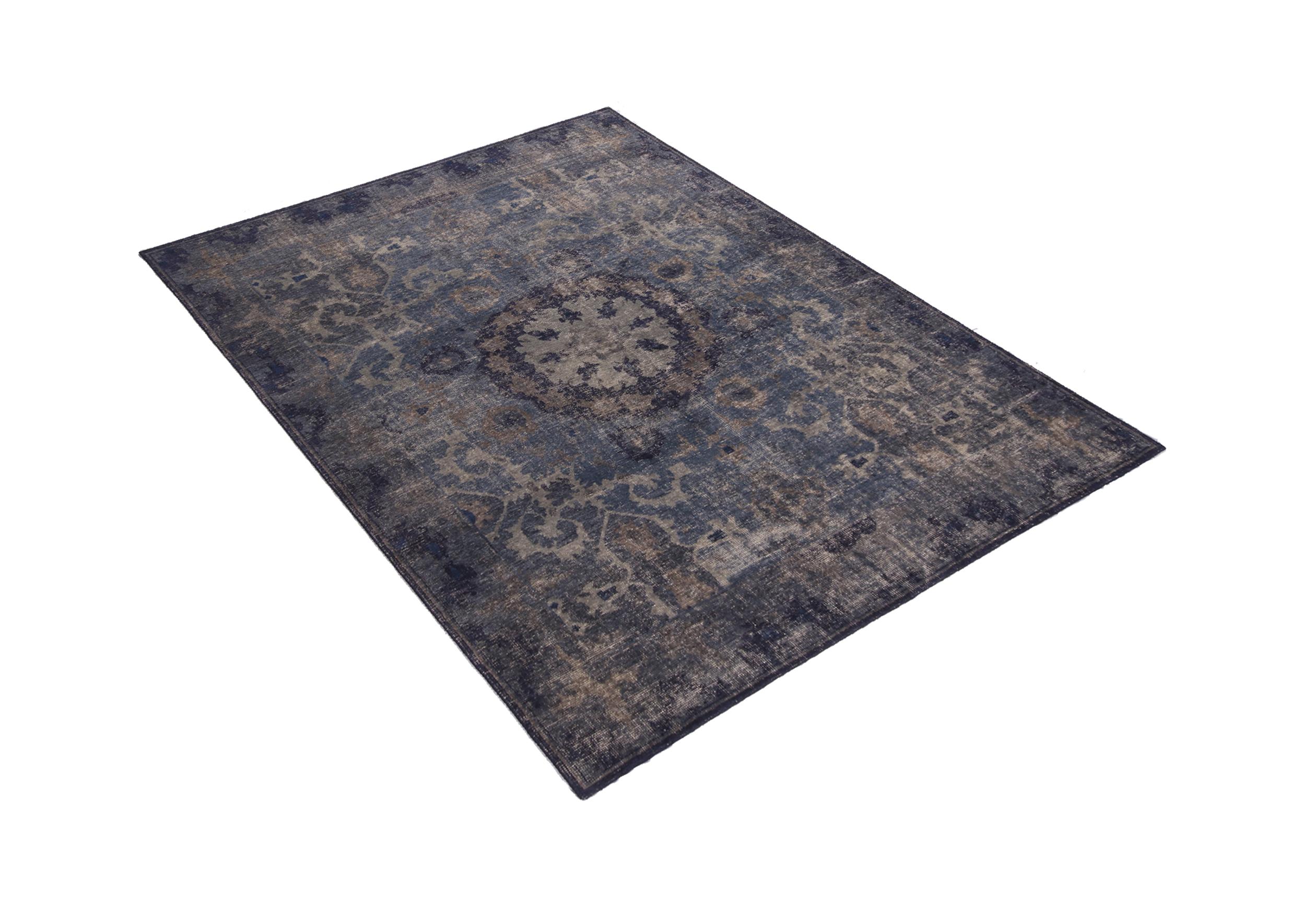 This contemporary hand knotted wool rug hails from Rug & Kilim’s Homage Collection, enjoying a finer take on distressed shabby chic aesthetic with fewer knots per square inch. The very Industrial navy and smoke blue colorways accent a variety of