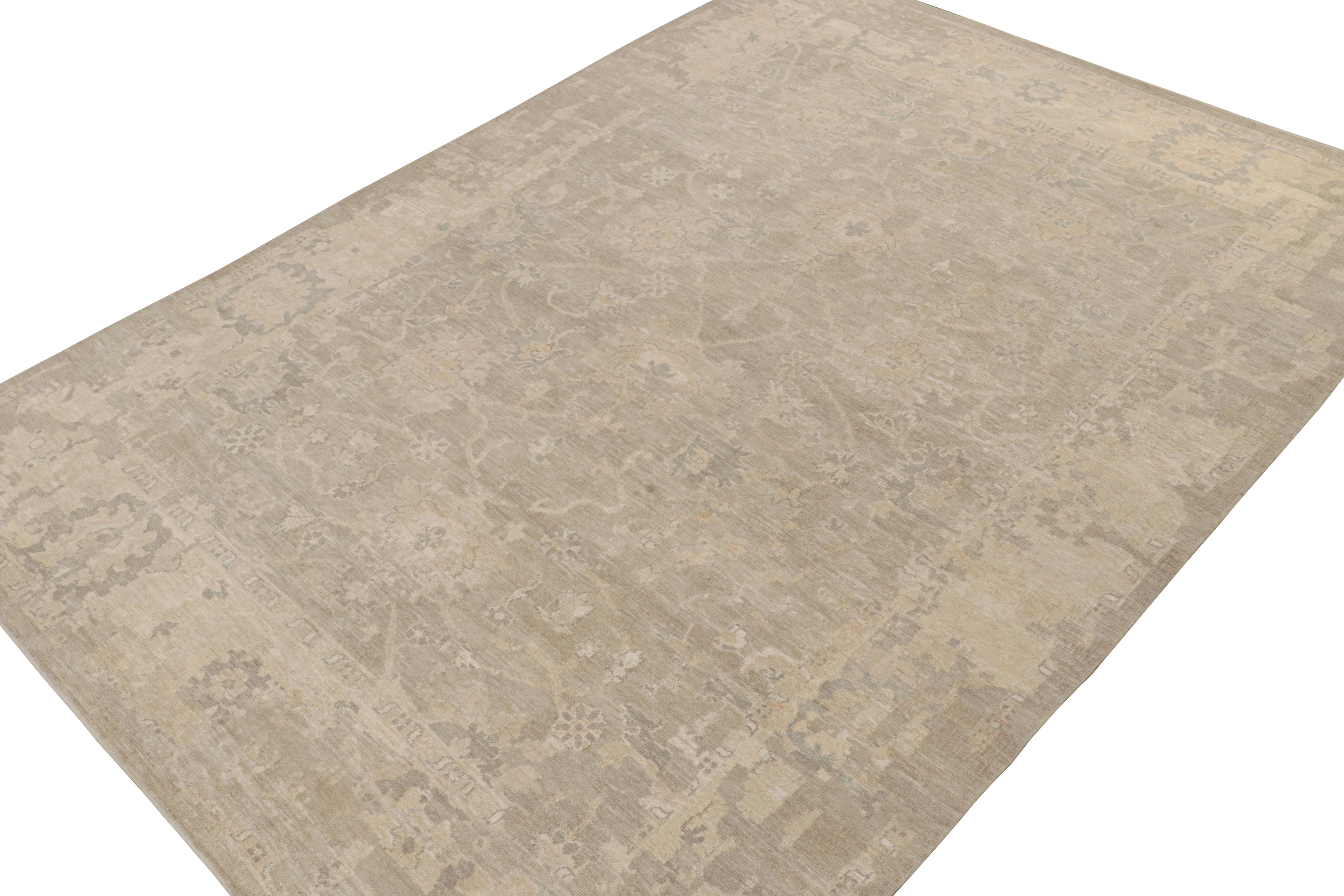 This 10x14 rug from the Modern Classics Collection by Rug & Kilim is from a new line inspired by antique Oushak rugs. Hand-knotted in silk, its design enjoys beige and silver-gray floral patterns with ivory accents and neutral tones. 

On the