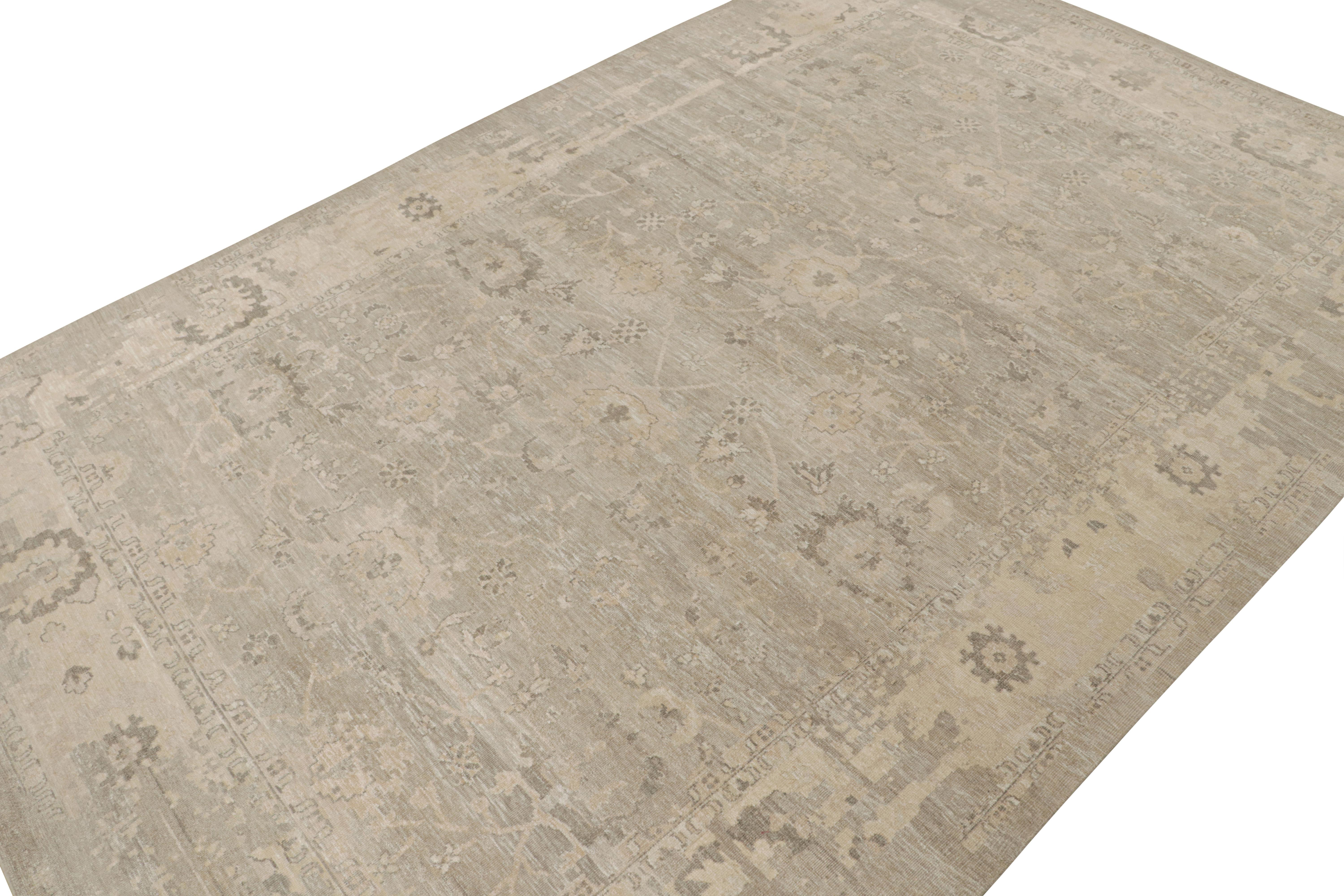 This 12x18 oversized rug from the Modern Classics Collection by Rug & Kilim is from a new line inspired by antique Oushak rugs. Hand-knotted in silk, its design enjoys beige and silver-gray floral patterns with ivory accents and neutral tones. 

On