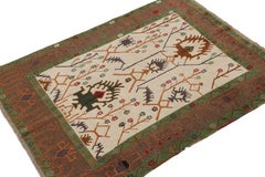 Rug & Kilim’s Oushak style rug in Beige with Green and Rust Geometric Patterns