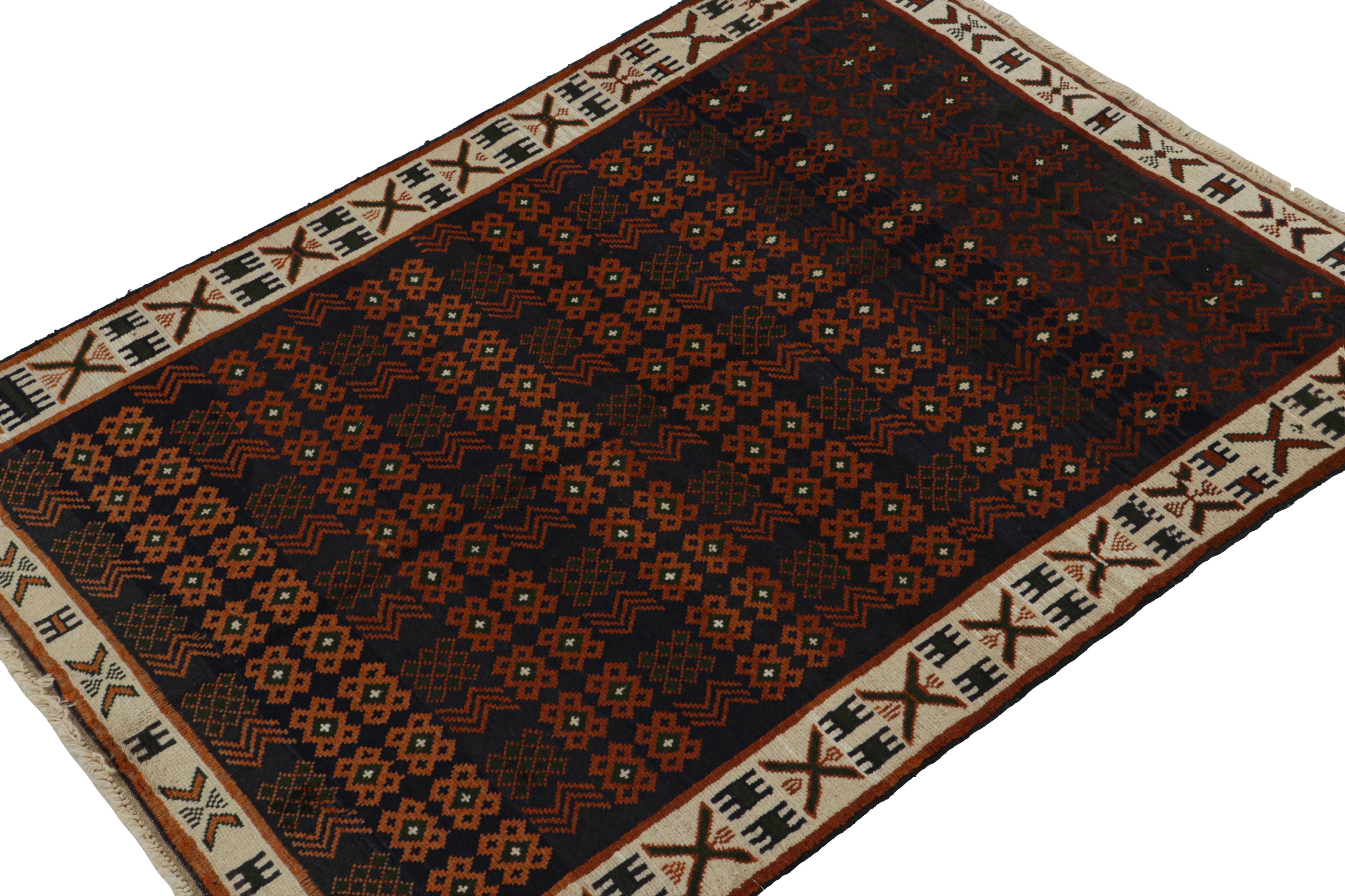 Inspired by Oushak tribal rugs, this 5x6 rug is the latest to join Rug & Kilim’s Modern Classics collection. 

Hand-knotted in wool, its design favors a navy blue field and beige border, with orange rust tone geometric patterns and green accents