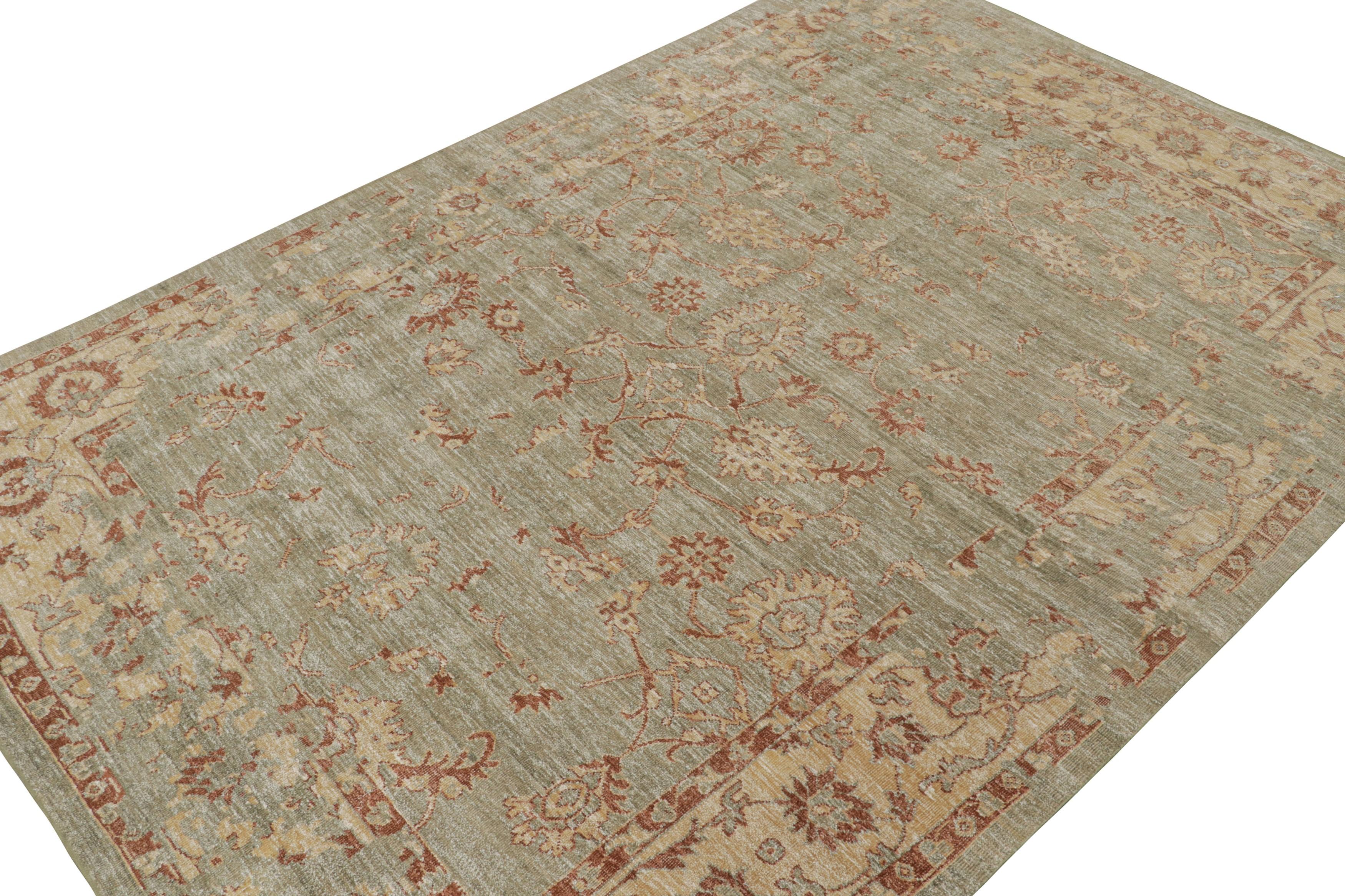 This 10x14 rug from the Modern Classics Collection by Rug & Kilim is from a new line inspired by antique Oushak rugs. Hand-knotted in silk, its design enjoys rust and gold floral patterns on a beige field with sage green accents. 

On the