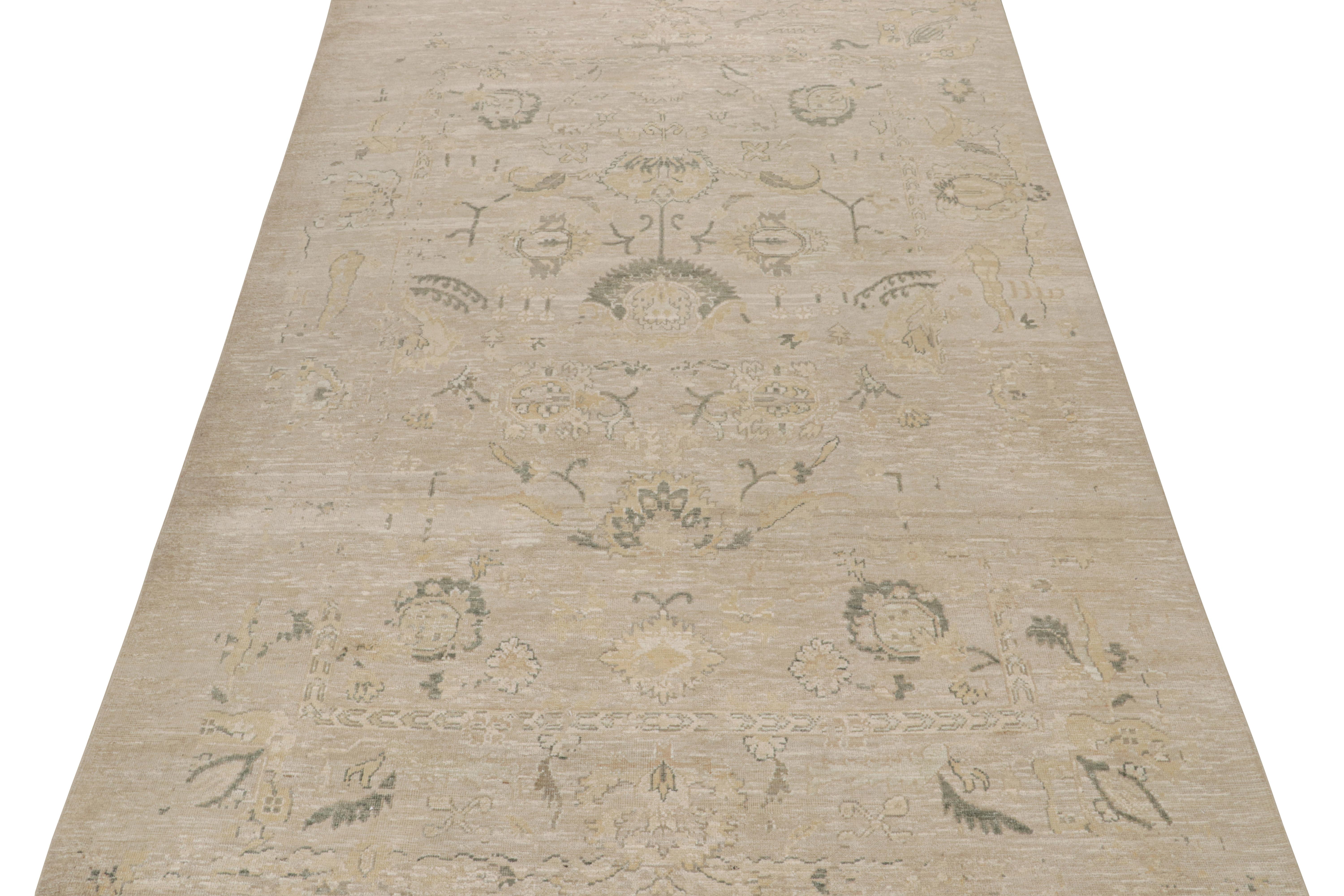 This 9x12 rug is inspired by antique Oushak rugs—from a bold new Modern Classics Collection by Rug & Kilim. Hand-knotted in silk, it enjoys taupe and beige-brown undertones with tribal motifs and floral patterns in gold and teal tones. 

On the