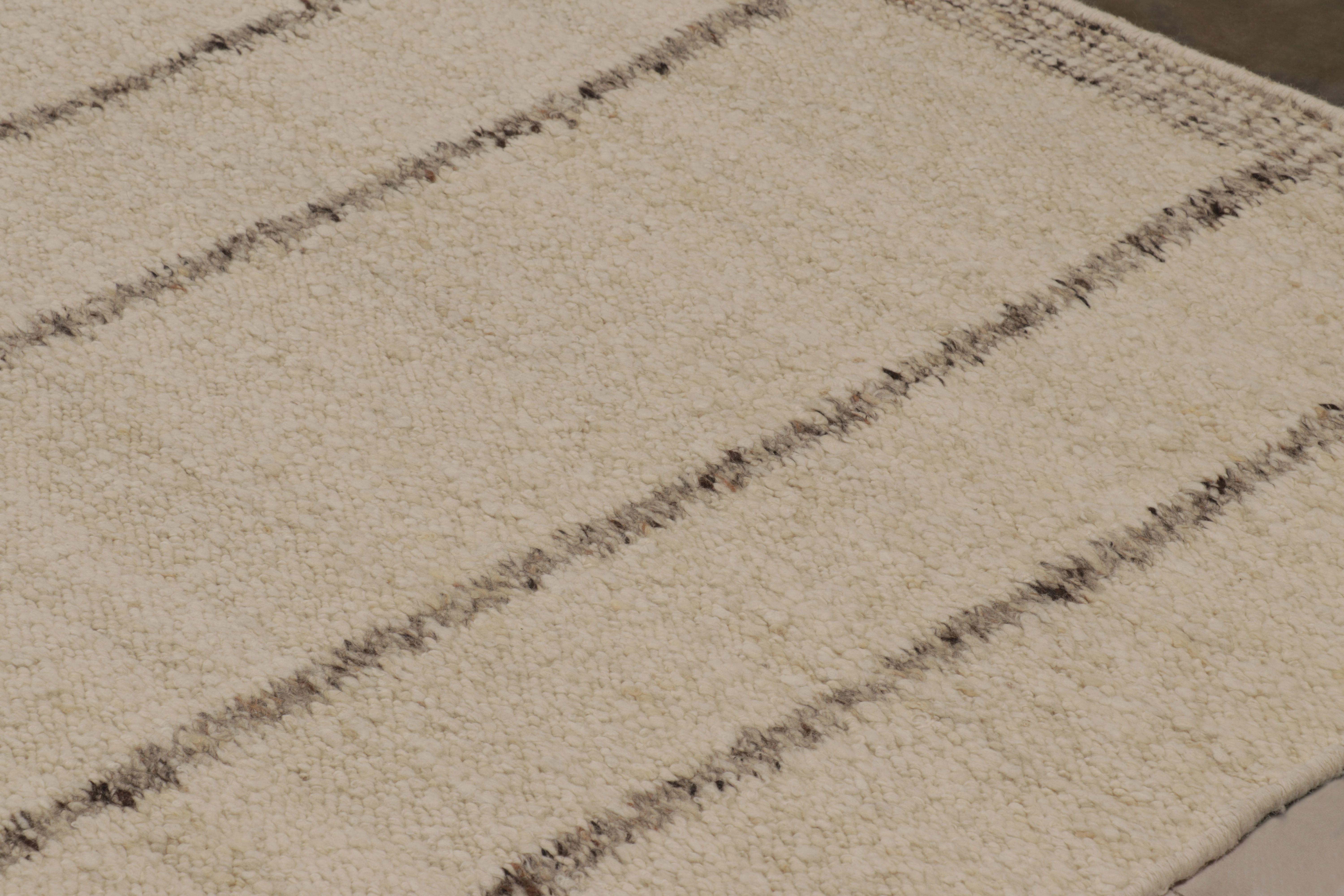 Dieses 12x18 große, moderne Flachgewebe aus Wolle und Baumwolle ist eine aufregende Neuheit in der Textural Collection von Rug & Kilim, die durch die Verwendung einer schlichten Farbpalette und das einzigartige Spiel mit Streifen, hohen und