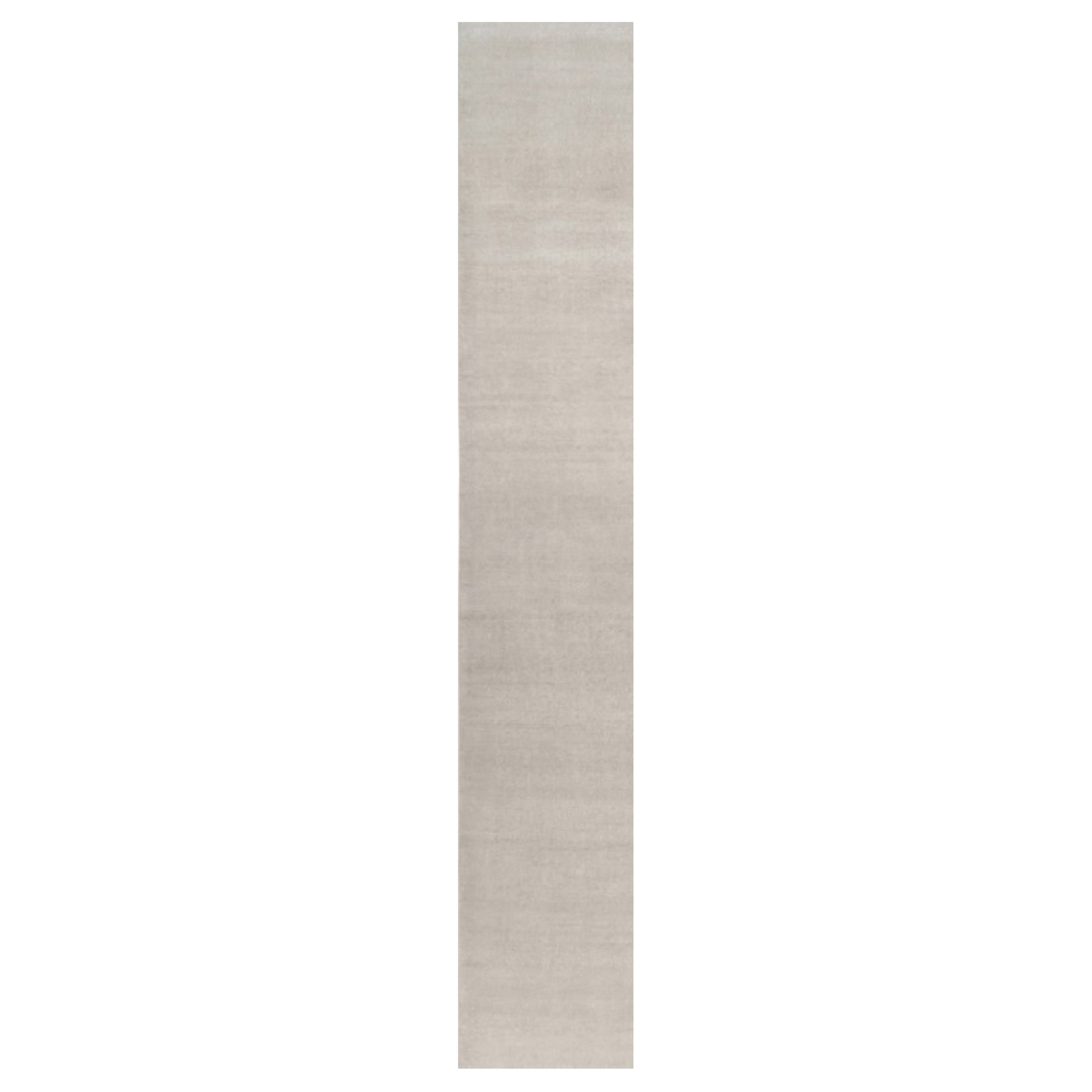 Rug & Kilim è un tappeto solido contemporaneo oversize dai toni avorio.
