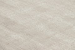 Rug & Kilim’s Oversized Contemporary Textural Solid Rug in Light Beige Tones