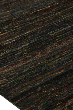 Rug & Kilim’s Oversized Textural Rug In Black with Bold Polychromatic Striae