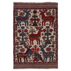 Rug & Kilim’s Persian Barjasta style rug in Beige with Red & Blue Deer Pictorial