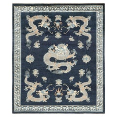 Rug & Kilim’s Pictorial Dragon Rug in Navy Blue, with Geometric Borders