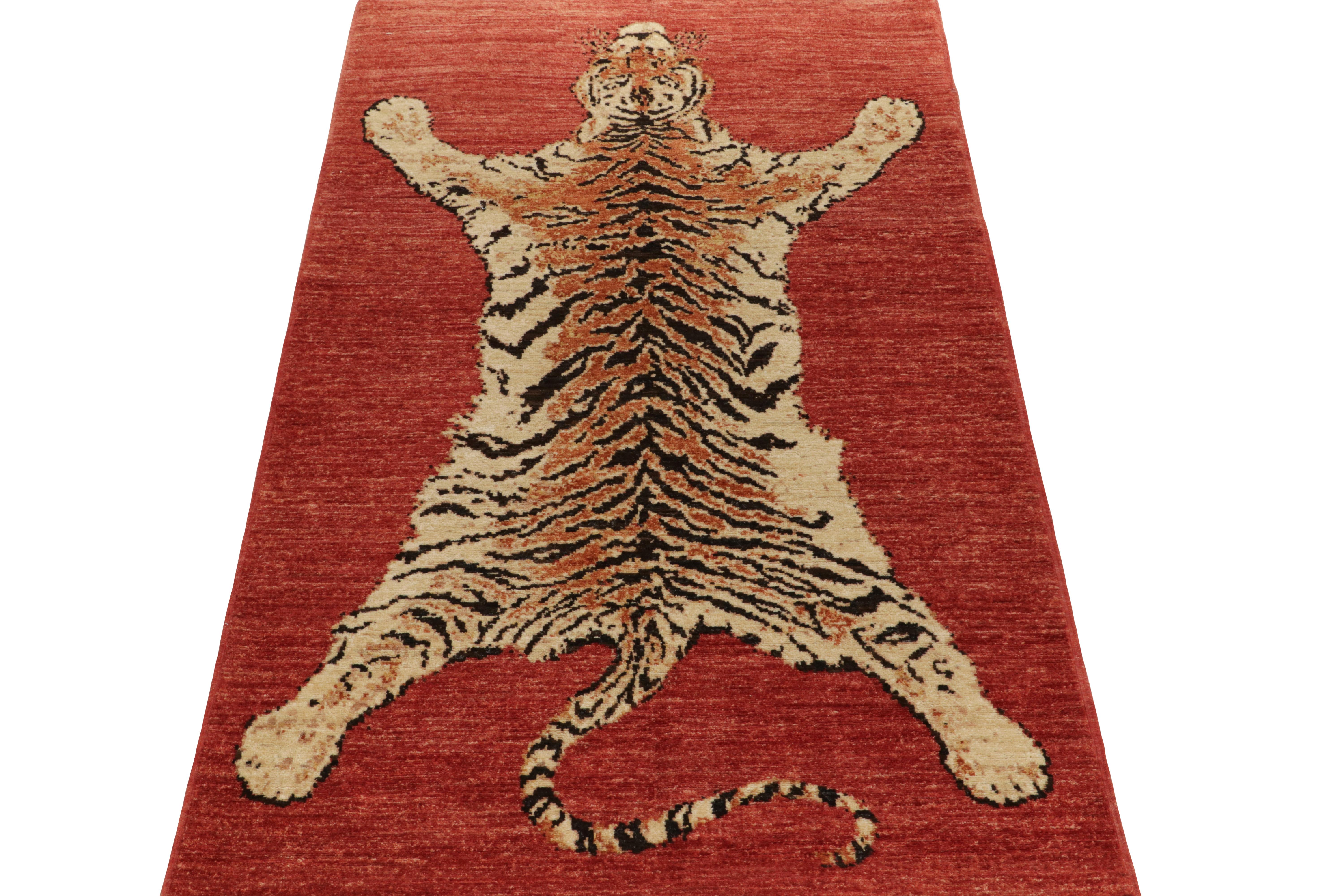 Hand knotted in wool, Rug & Kilim presents this 4x7 piece from its most graphic new collection, inspired by coveted Tiger skin rugs. An exemplary drawing, this pictorial enjoys a pelt pattern in beige-brown and orange on a striated red background of