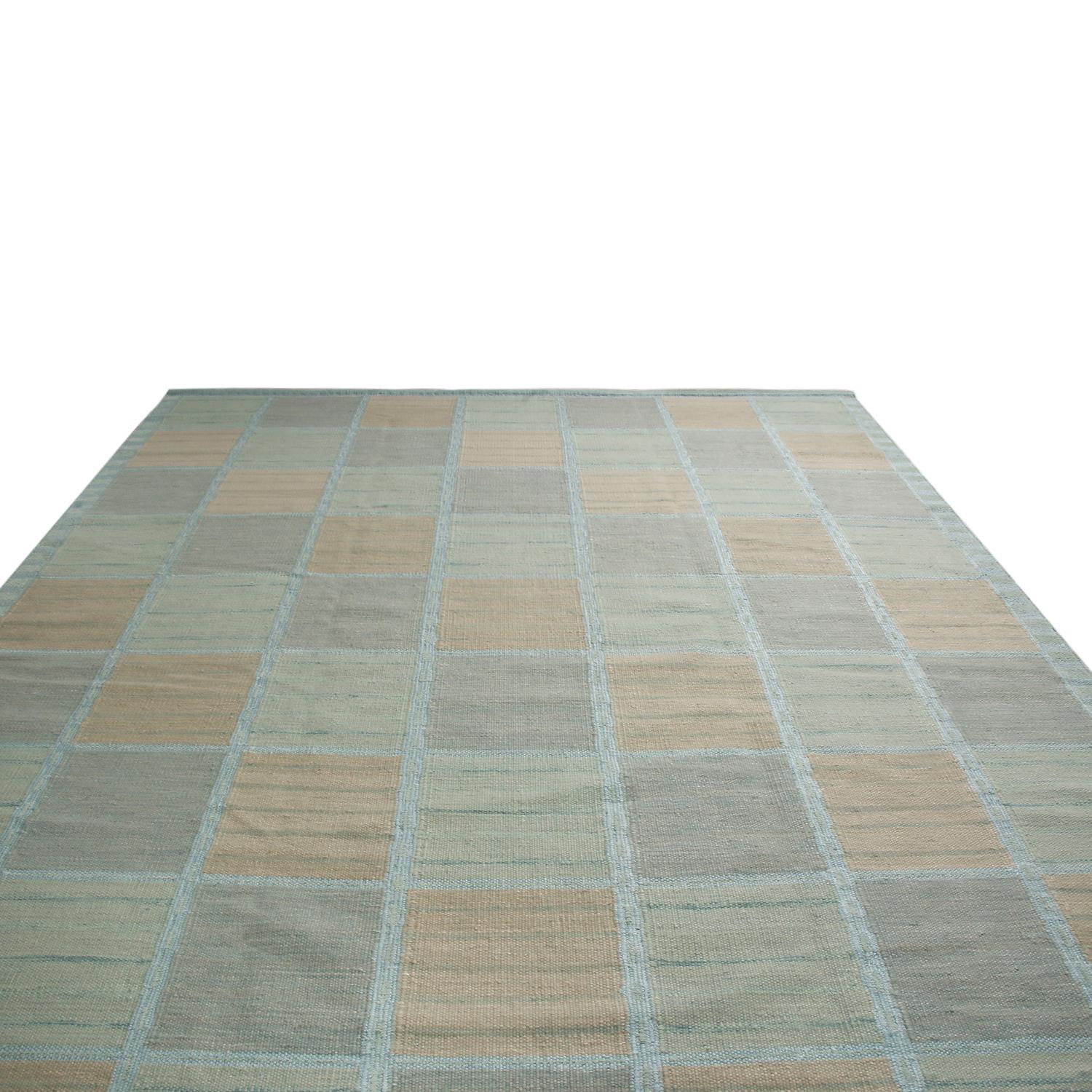 Originating from India, this hand knotted pile rug hails from Rug & Kilim’s Scandinavian-inspired collection, bound in high-quality New Zealand wool featuring a fine patchwork geometric field design in multi-tonal seafoam green-blue colorways with