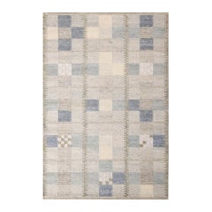 Rug
Kilim
s skandinavisch inspirierter geometrischer Teppich aus grauer und blauer Naturwolle