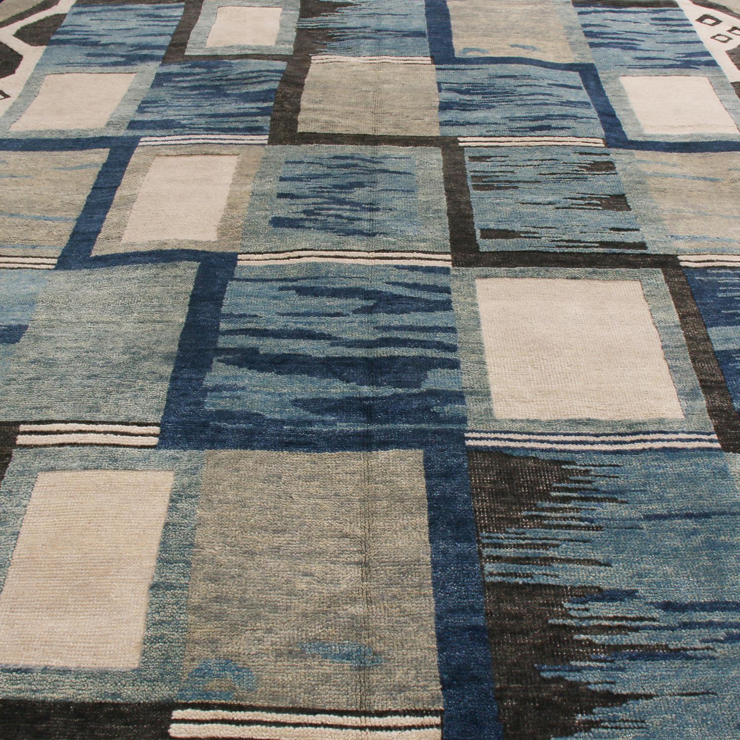 Originating from India, this hand knotted contemporary pile rug hails from Rug & Kilim’s Scandinavian-inspired collection, featuring a distinct tribal geometric all-over field design with bold black, off-white, gray, and multi-tonal blue colorways;