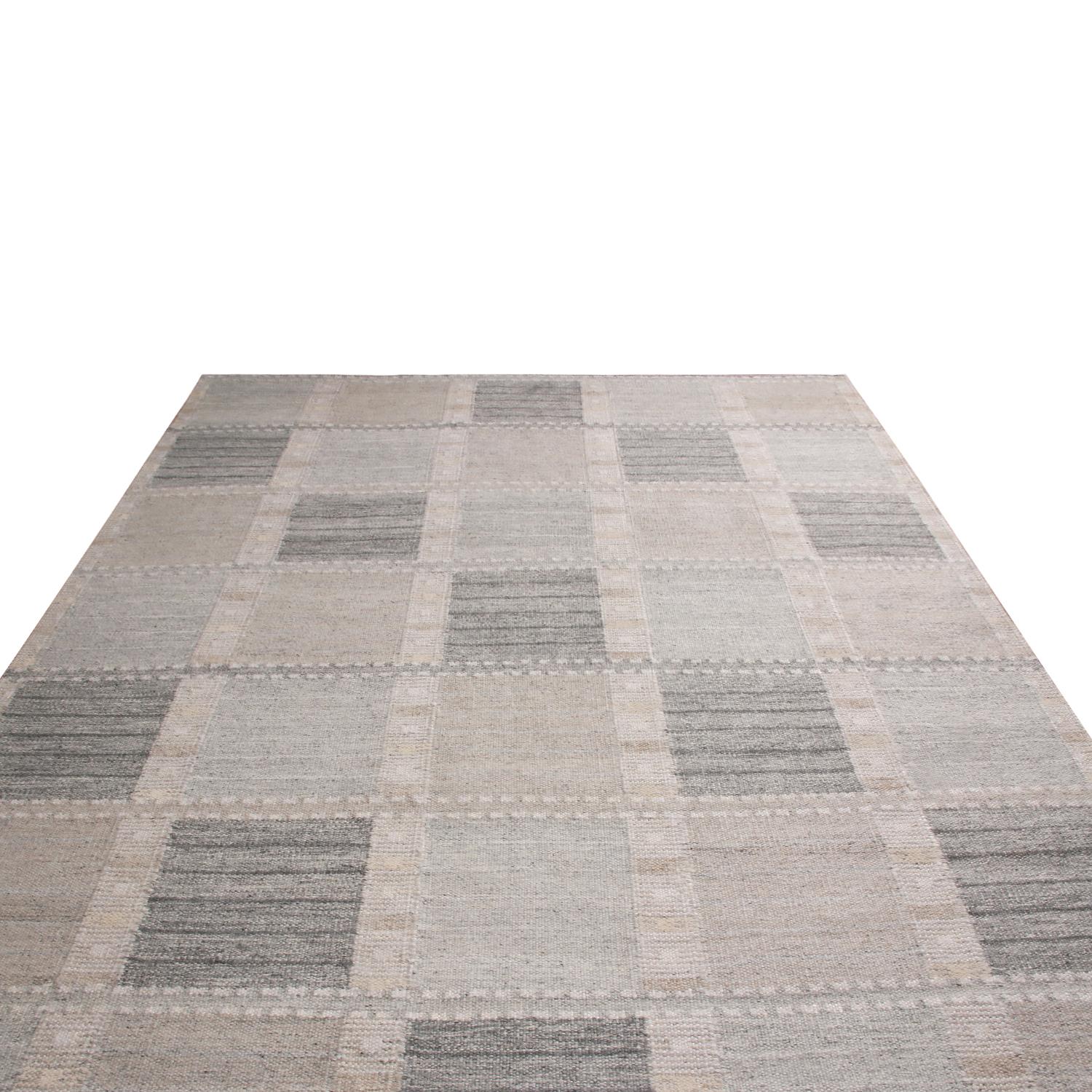 Originating from India, this hand knotted wool pile rug hails from Rug & Kilim’s Scandinavian collection, patchwork-inspired geometric all-over field design with off-white, gray and multi-tonal blue colorways bound in natural yarn, available in full