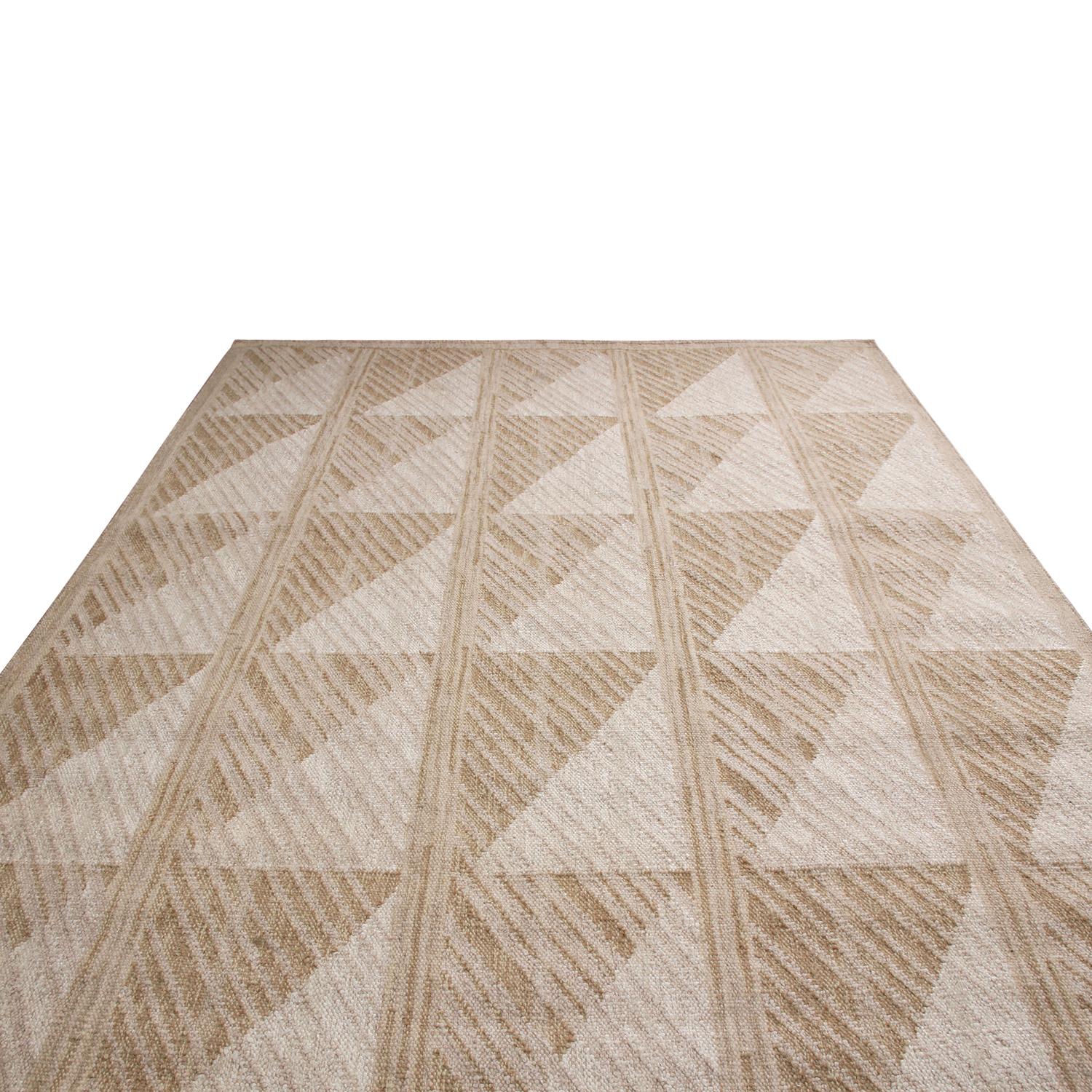 Originario dell'India, questo tappeto in lana naturale annodato a mano fa parte della collezione Scandinavian di Rug & Kilim, con un disegno geometrico all-over di ispirazione patchwork nei colori tan, pesca e bianco sporco; disponibile in tutti i