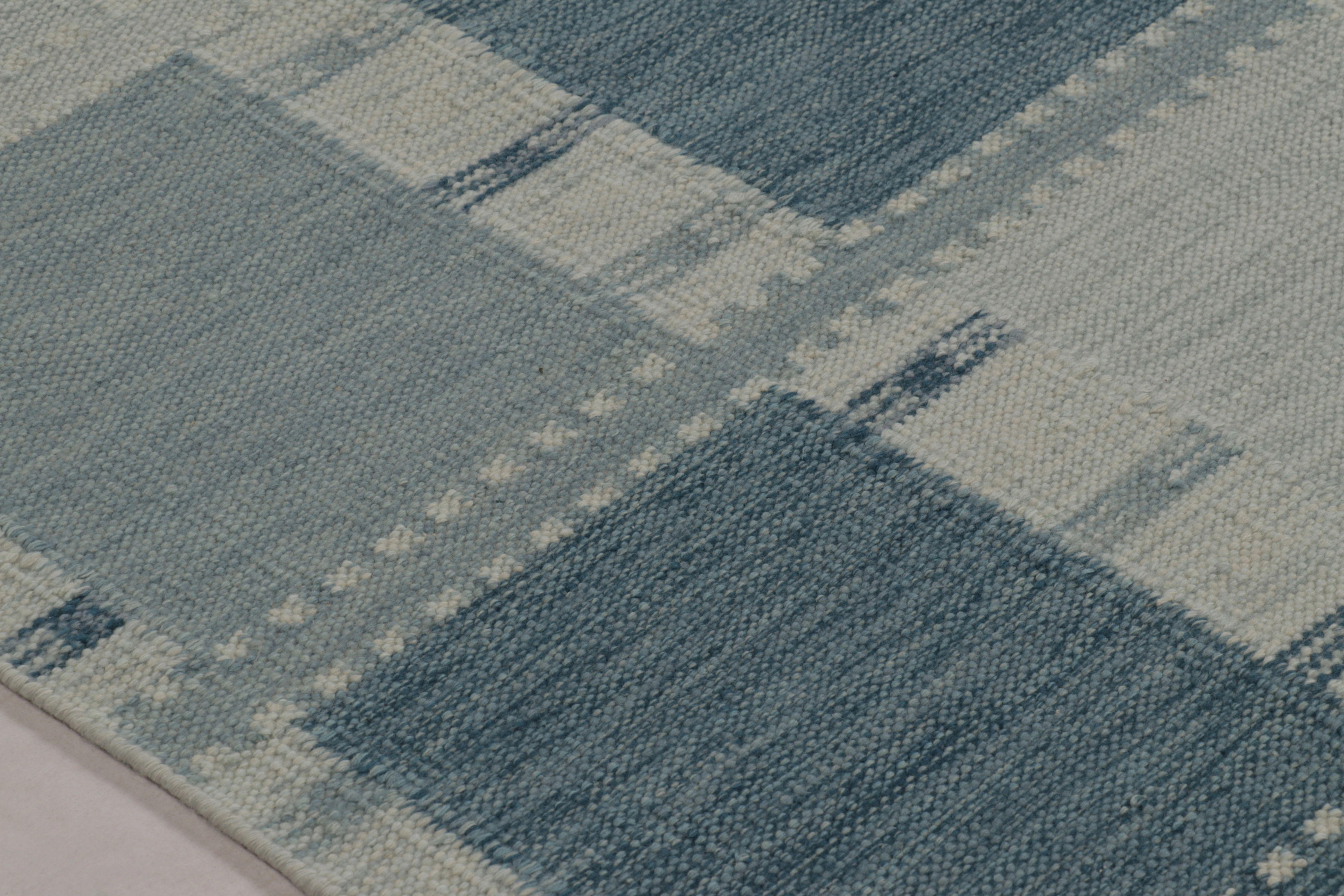 Dieses 8x10 große skandinavische Flachgewebe von Rug & Kilim ist aus Wolle handgewebt und zeigt ein klassisches Schachbrettmuster in einer raffinierten monochromen Farbpalette aus Denimblau, Schiefergrau und Hellblau. Diese firmeneigene