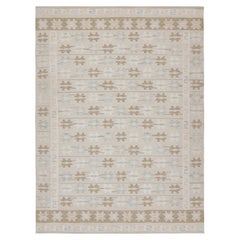 Rug & Kilim è un kilim in stile scandinavo con motivi geometrici color taupe e beige-marrone.