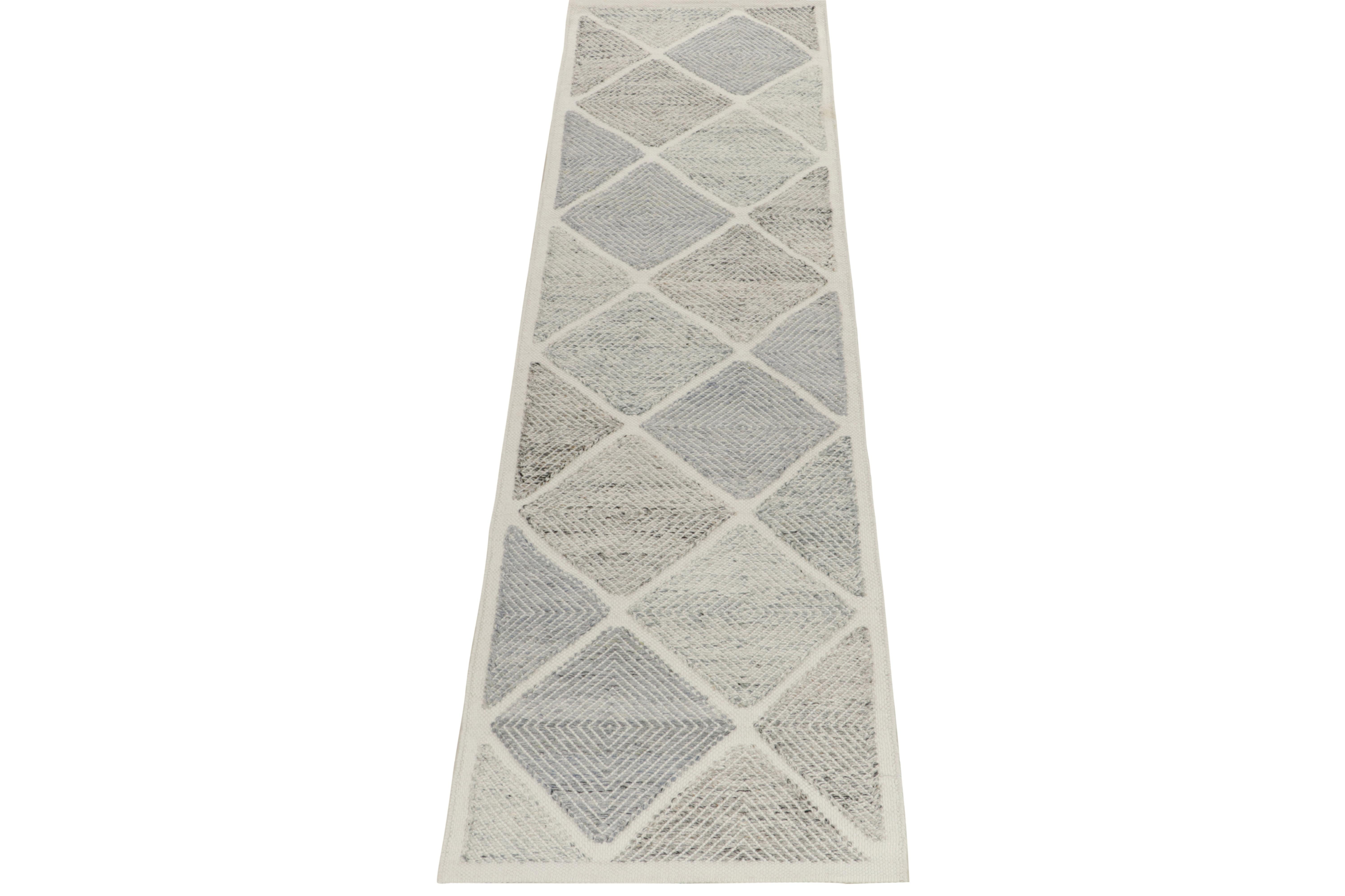 Rug & Kilim presents this exquisite 3x10 Scandinavian kilim from the Morocco line of the titular, award-winning flat weave texture. The handwoven runner flows in an all over diamond pattern in a delightful montage of stone gray, blue & white. The