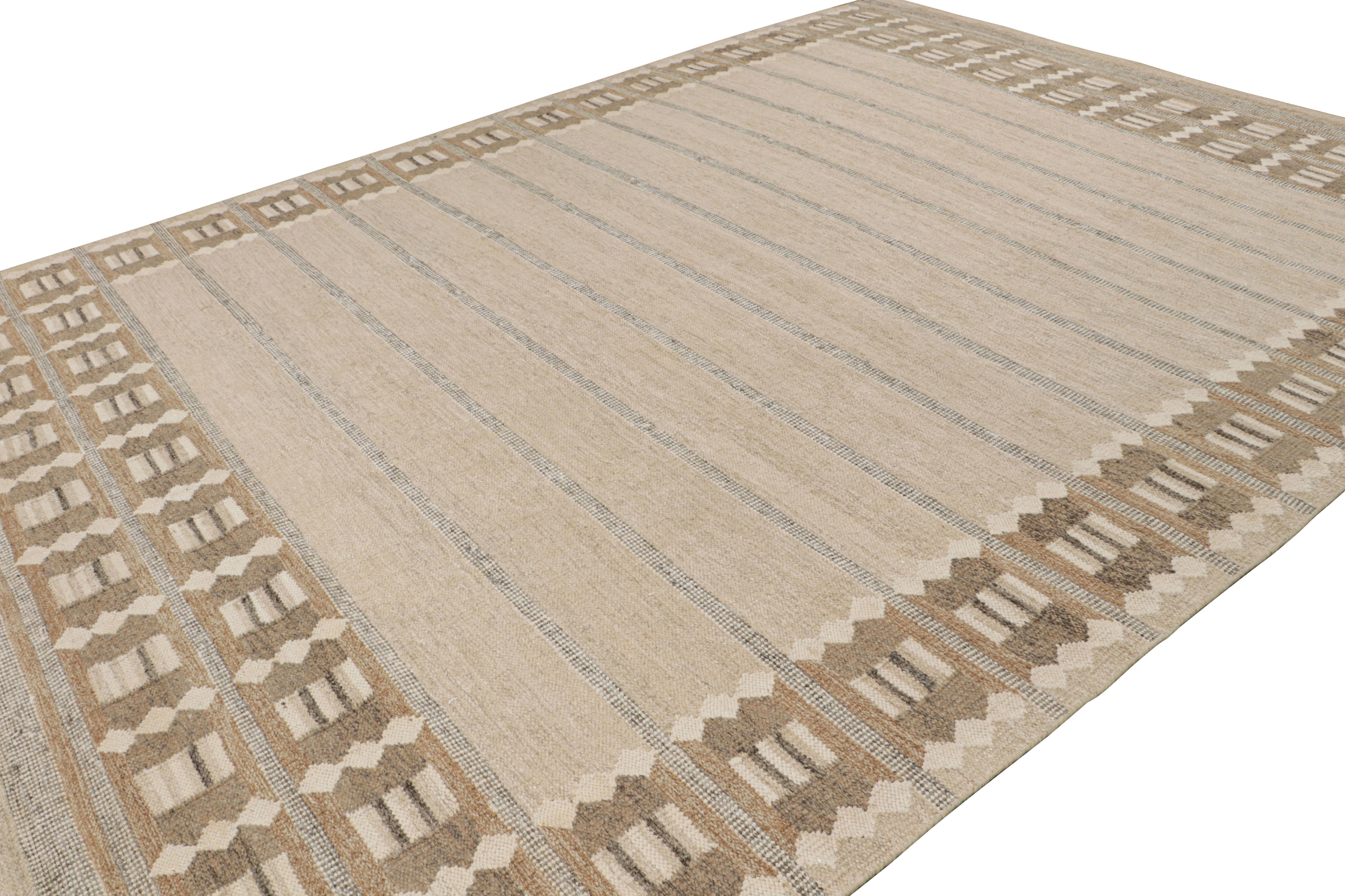 Hand-knotted in aloe, this 11x15 Scandinavian rug features beige-brown and other neutrals and earth tones underscoring a play of stripes and geometric patterns in field and border alike, all inspired by the Swedish minimalist aesthetic. 

On the