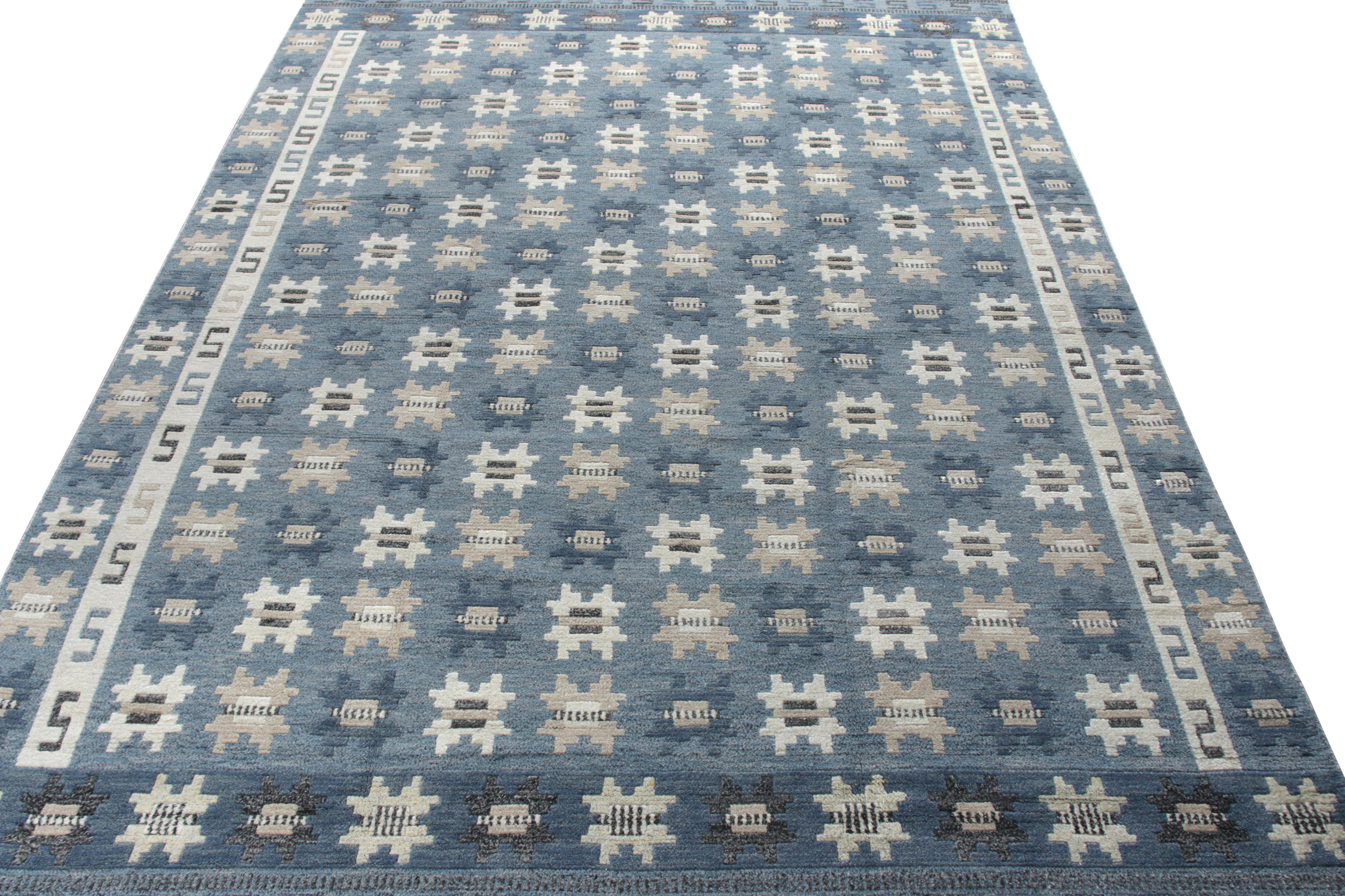 A scintillating 10x14 piece from Rug & Kilim’s Scandinavian Collection. Hand-knotted in wool with a skillful a high-low texture, this pile features a repetitive geometric that runs in gray and white on a blue background, playing perfectly with the