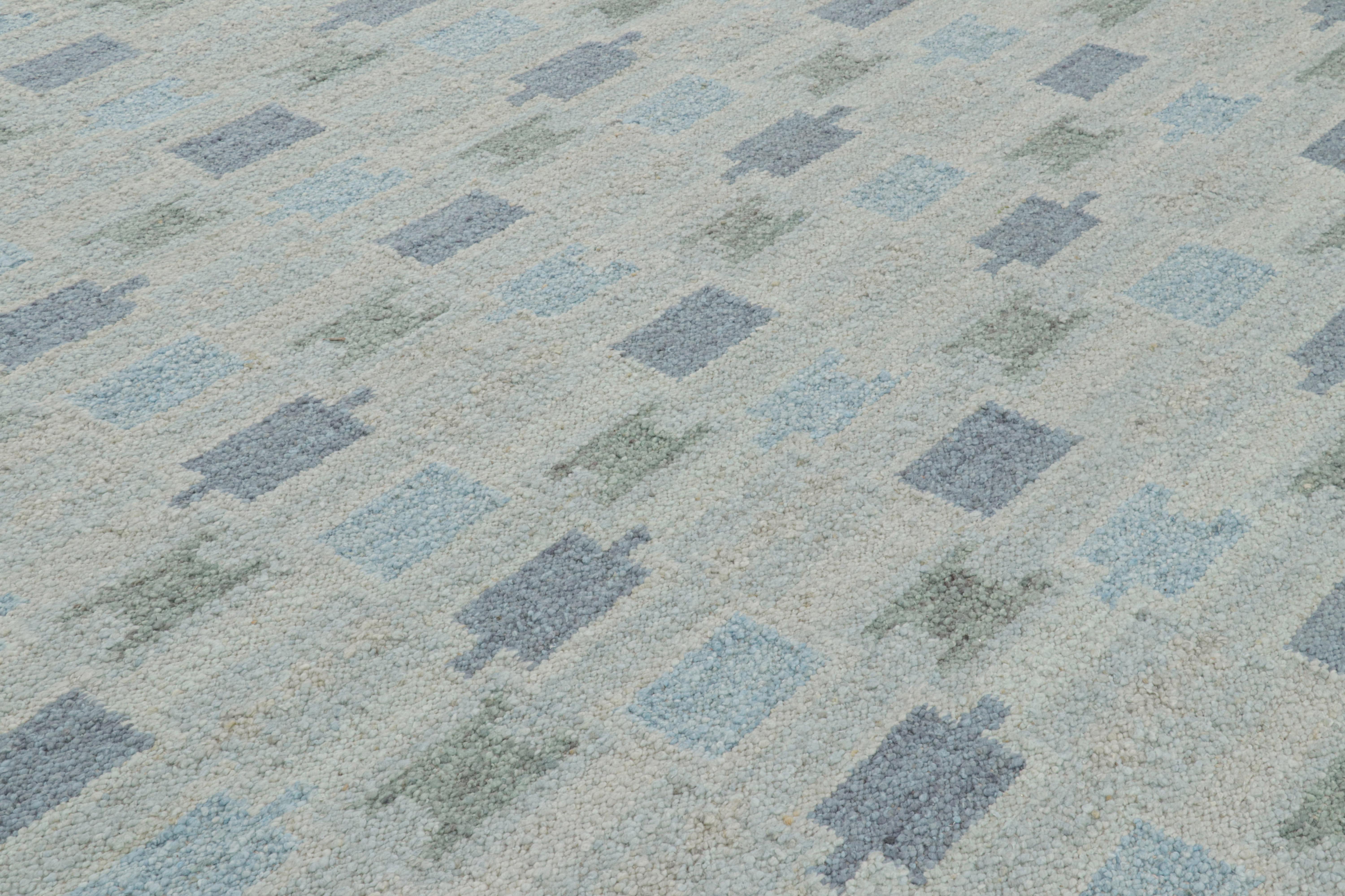 Ce tapis 10x14 de style suédois, tissé à la main en laine, est issu de la texture inventive 