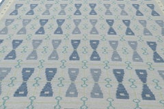 Rug & Kilim’s Scandinavian Style Rug in Blue Tones with Hourglass Patterns
