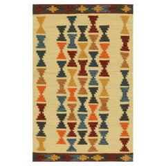 Rug & Kilim’s Scandinavian Style Rug with Polychromatic Hourglass Patterns