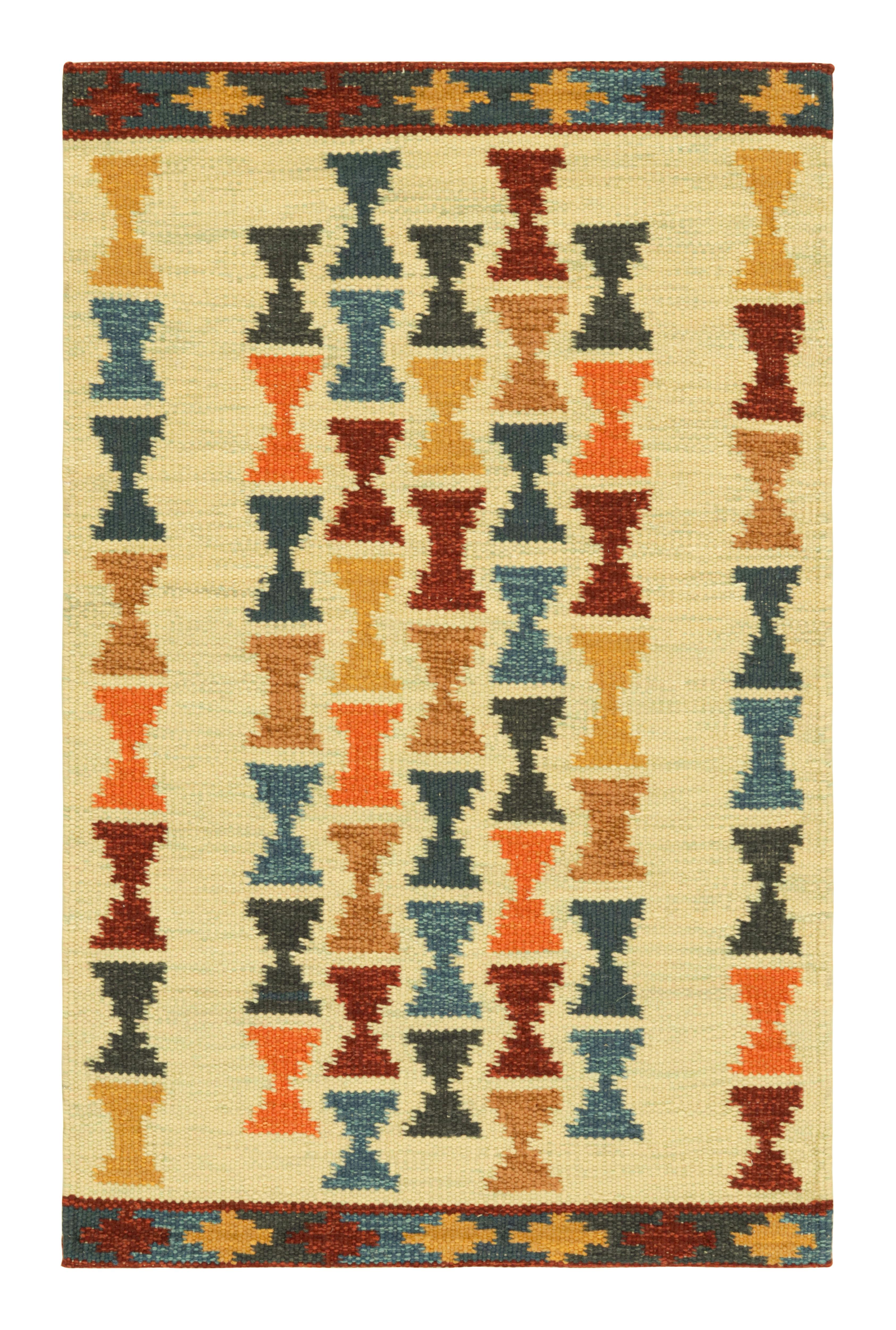 Rug & Kilim’s Scandinavian Style Rug with Polychromatic Hourglass Patterns