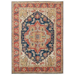 Rug & Kilim’s Serapi style rug in Navy Blue with Gold and Red Medallion