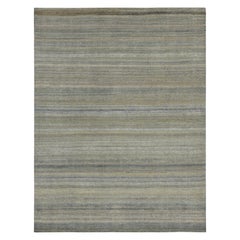 Rug
Kilim è un tappeto testurizzato a righe e strisce blu, beige e grigie.