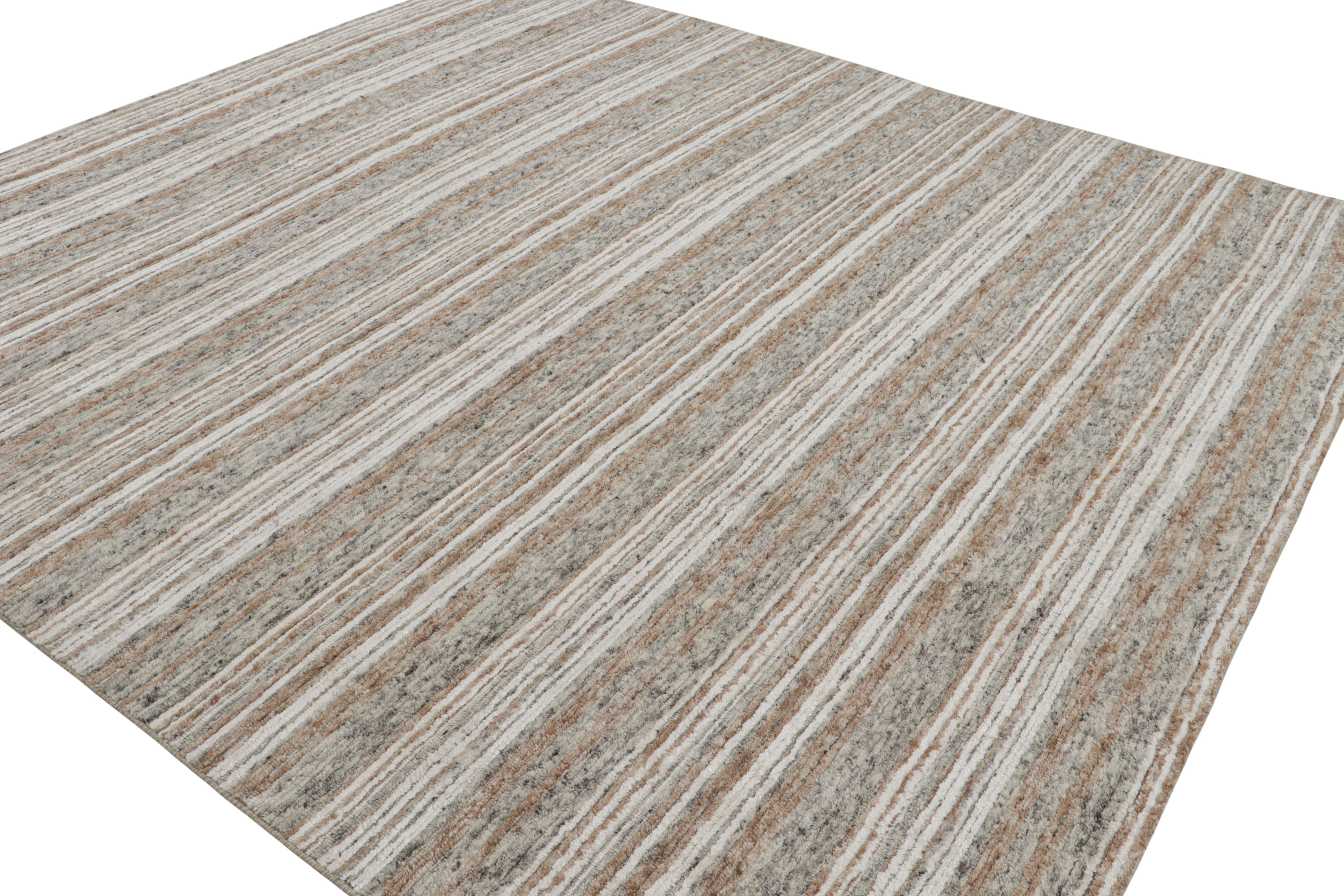Made with wool and art silk, this 9x10 modern textural rug with geometric patterns features beige-brown, gray and white hues underscore a series of stripes in the all over style.  

On the Design: 

This contemporary design is an homage to art via