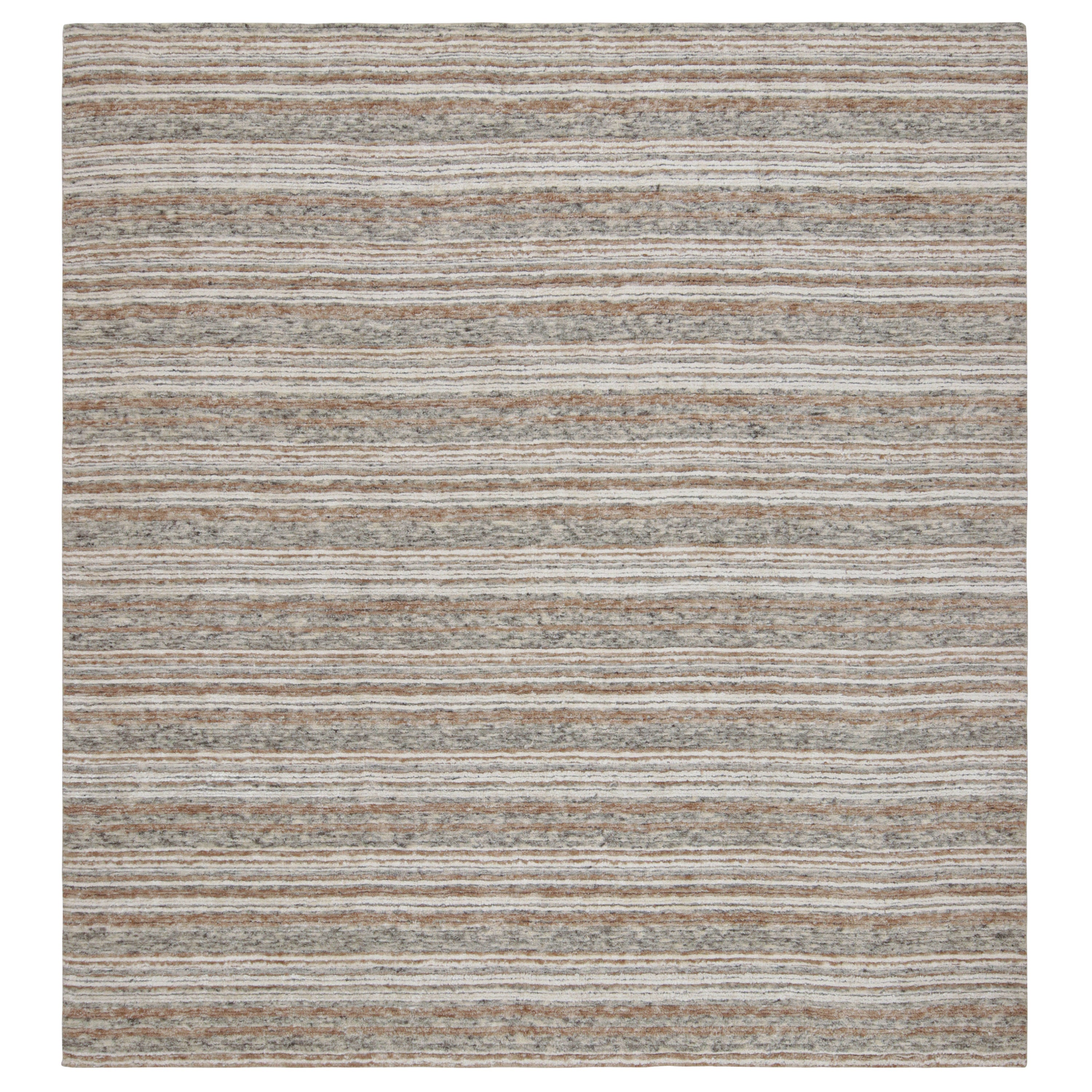 Dieser 9x10 große, moderne Teppich mit geometrischen Mustern aus Wolle und Kunstseide zeichnet sich durch beige-braune, graue und weiße Farbtöne aus, die eine Reihe von Streifen im Allover-Stil unterstreichen.  

Über das Design: 

Dieses