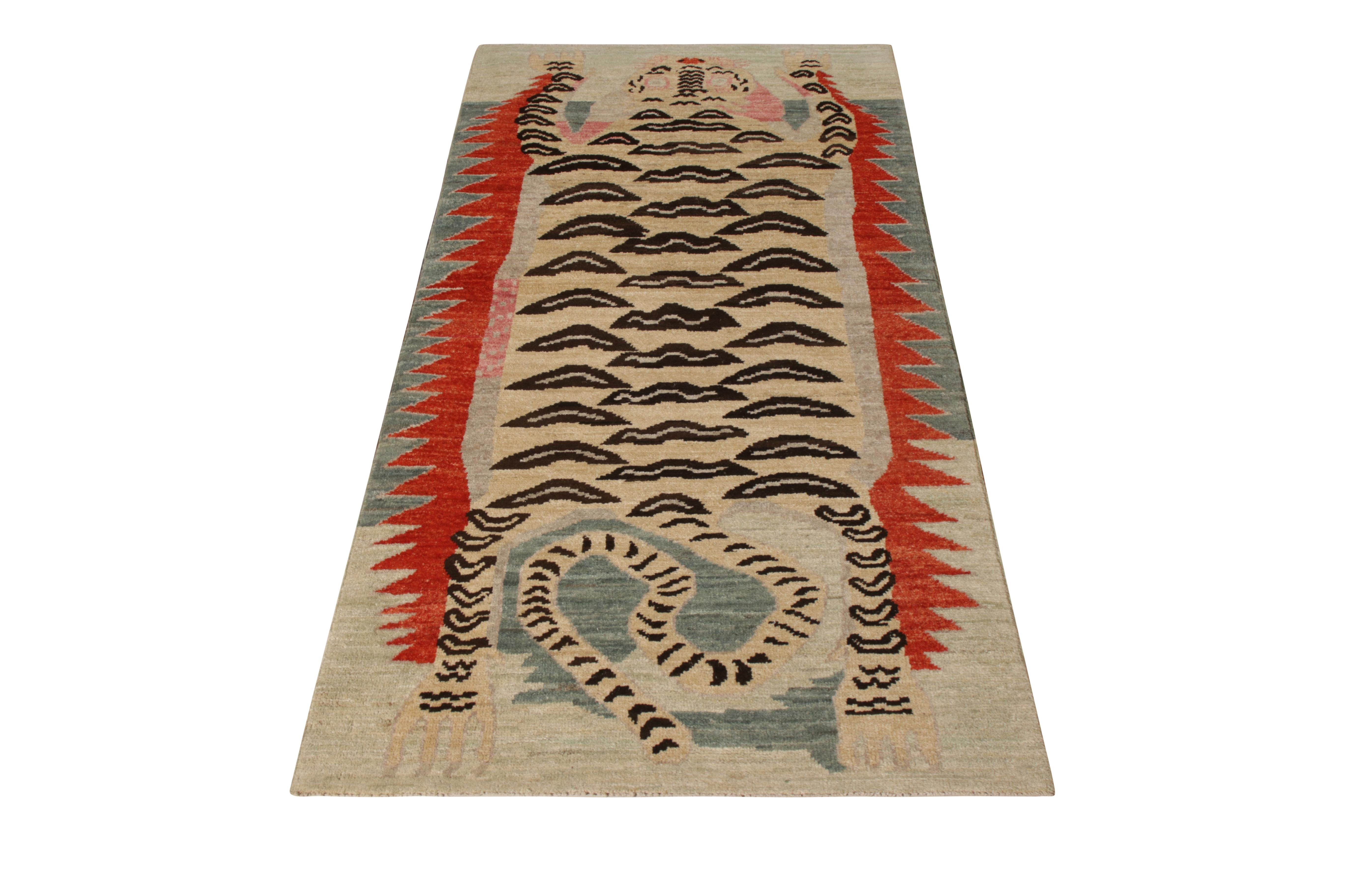 A 2 x 6 ode to classic Tibetan Tiger rug styles, from the latest collection by Rug & Kilim. Hand knotted in wool, recapturing the bold pictorial style in more modern beige-brown hues with lively red and blue accents. Exemplifying the individualistic