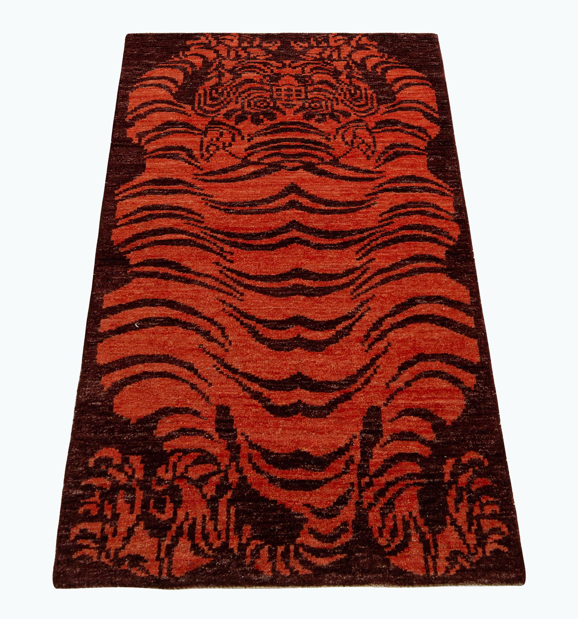 A 3x6 runner inspired by classic Tibetan Tiger rug styles, from the titular new collection by Rug & Kilim. Hand knotted in wool, enjoying rich, abrashed hues of orange against burgundy in a fierce and warm, curvaceous style. Exemplative in its