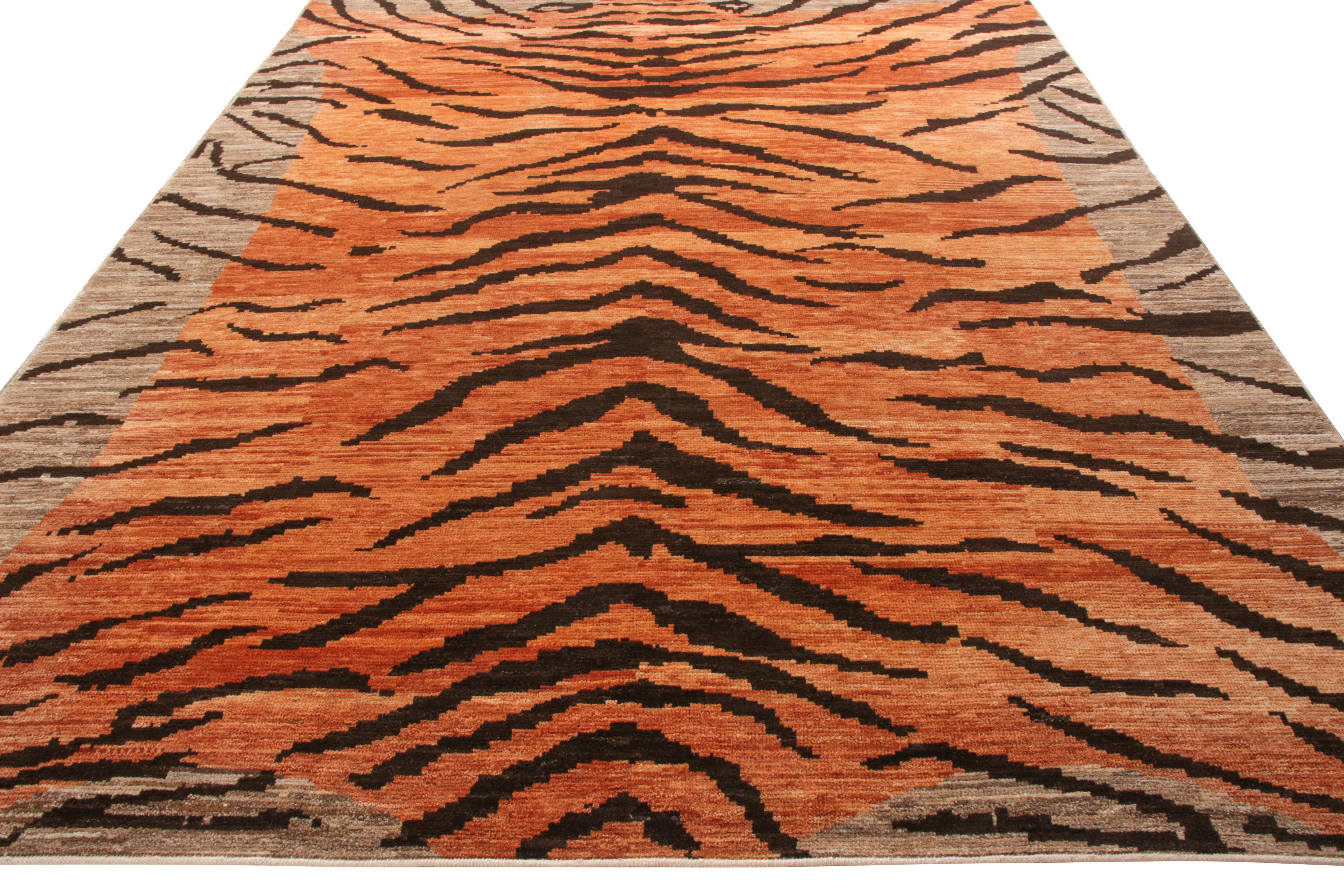 Rug & Kilim presents this 9 x 12 rug from its newly unveiled Tigers Collection. Hand knotted in wool, this rich rug surrounds itself in a commanding aura that is reflected in its pictorial representation of luscious orange and black stripes settling