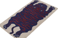 Rug & Kilim’s Tiger-Skin Rug in White with Blue & Red Pictorial