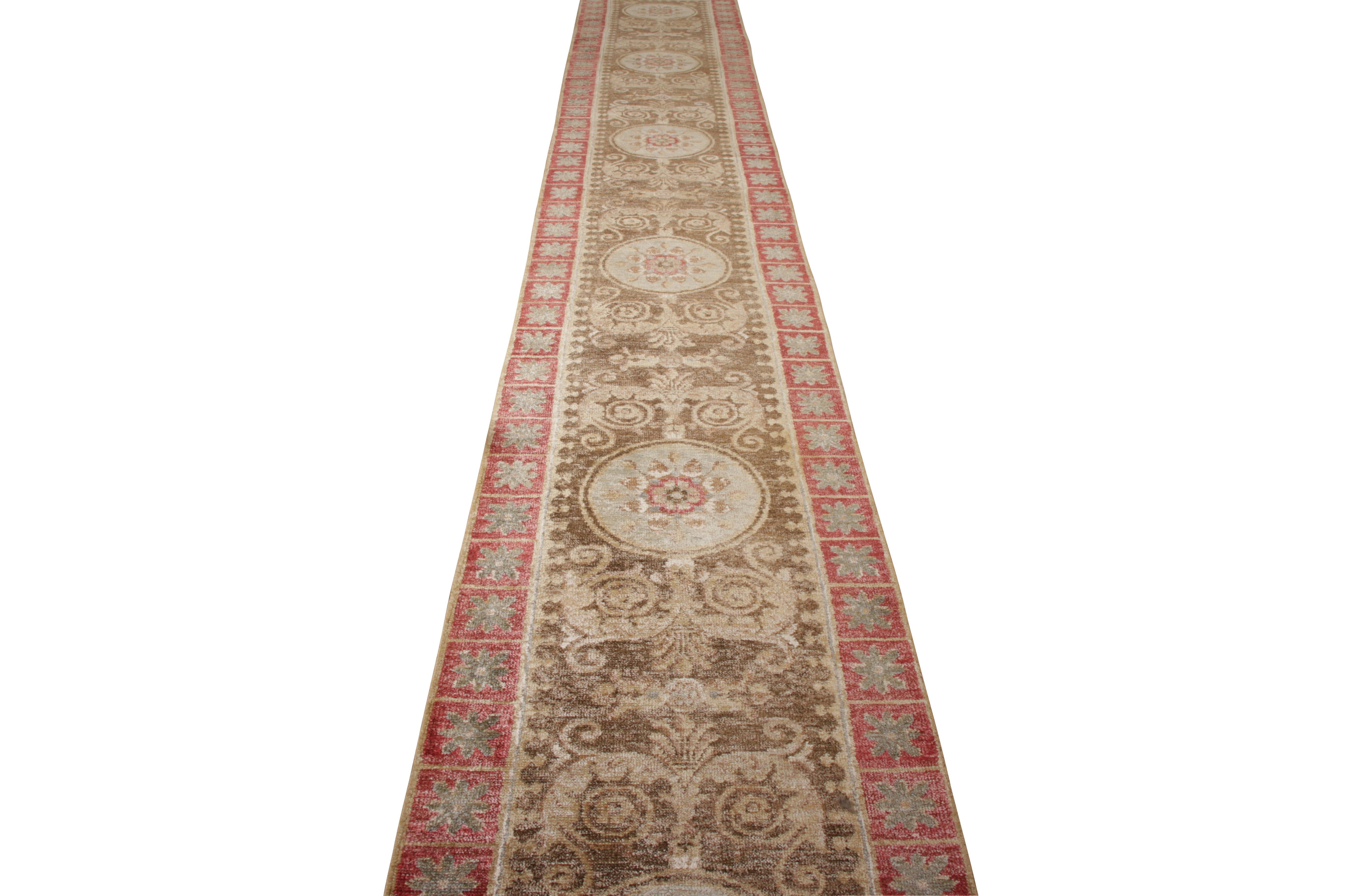 A brilliant 3×22 runner nodding to classic transitional rug styles, from Rug & Kilim’s Modern Classics Collection. Hand knotted in wool, enjoying repeating medallion floral patterns in a forgiving, subtle blue within beige-brown and red. Exceptional