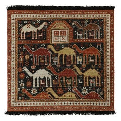 Rug & Kilim è un tappeto in stile tribale in nero con motivi pittorici rossi, oro e marrone.