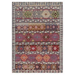 Alfombra de estilo tribal con motivos geométricos policromáticos de Rug & Kilim