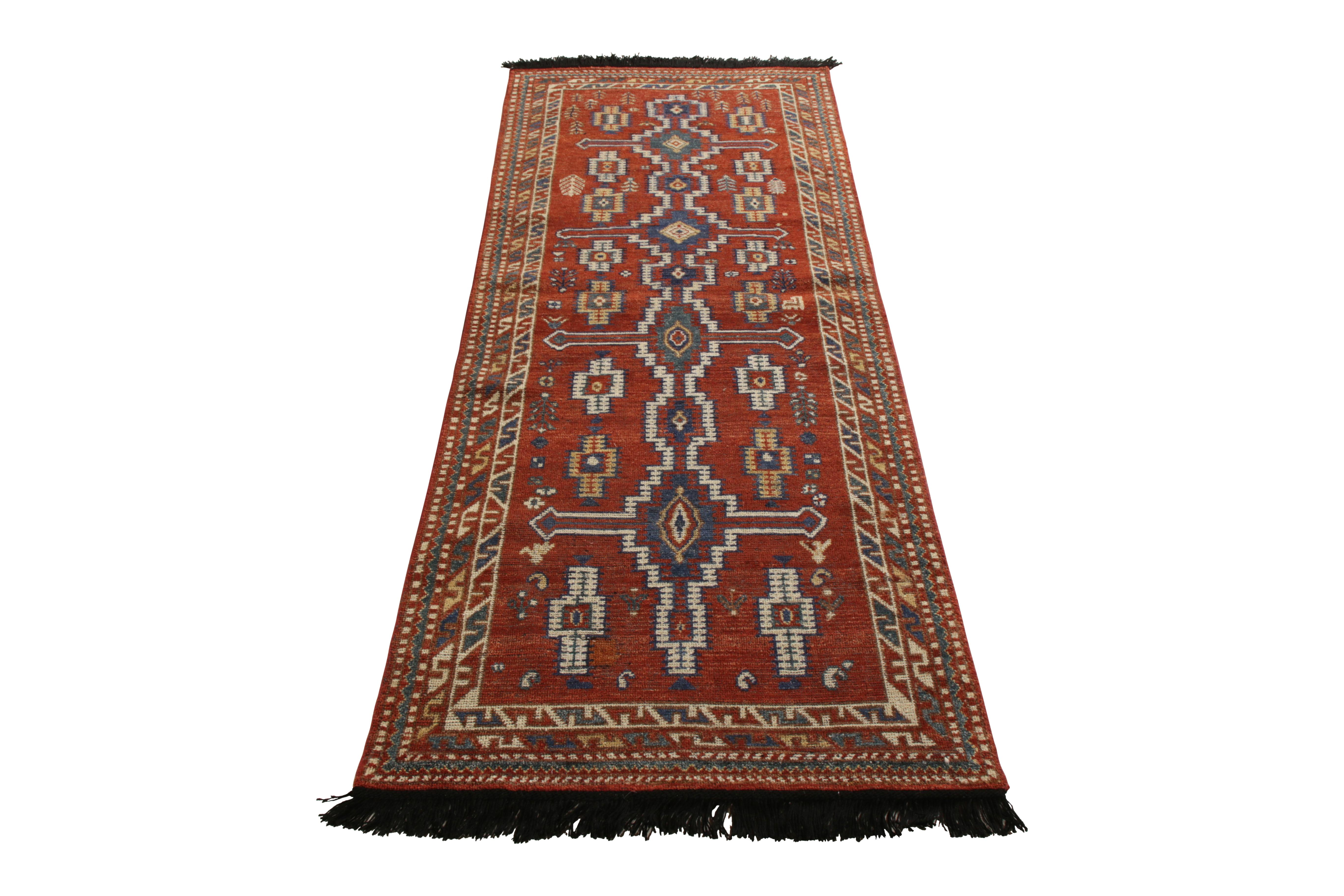 A 3 x 8 runner nodding to celebrated tribal rug styles, from Rug & Kilim’s Burano Collection. Hand knotted in notably soft Ghazni wool, enjoying rich burn red and blue hues with intricate all over geometric patterns. A rich play of warm-and-cool