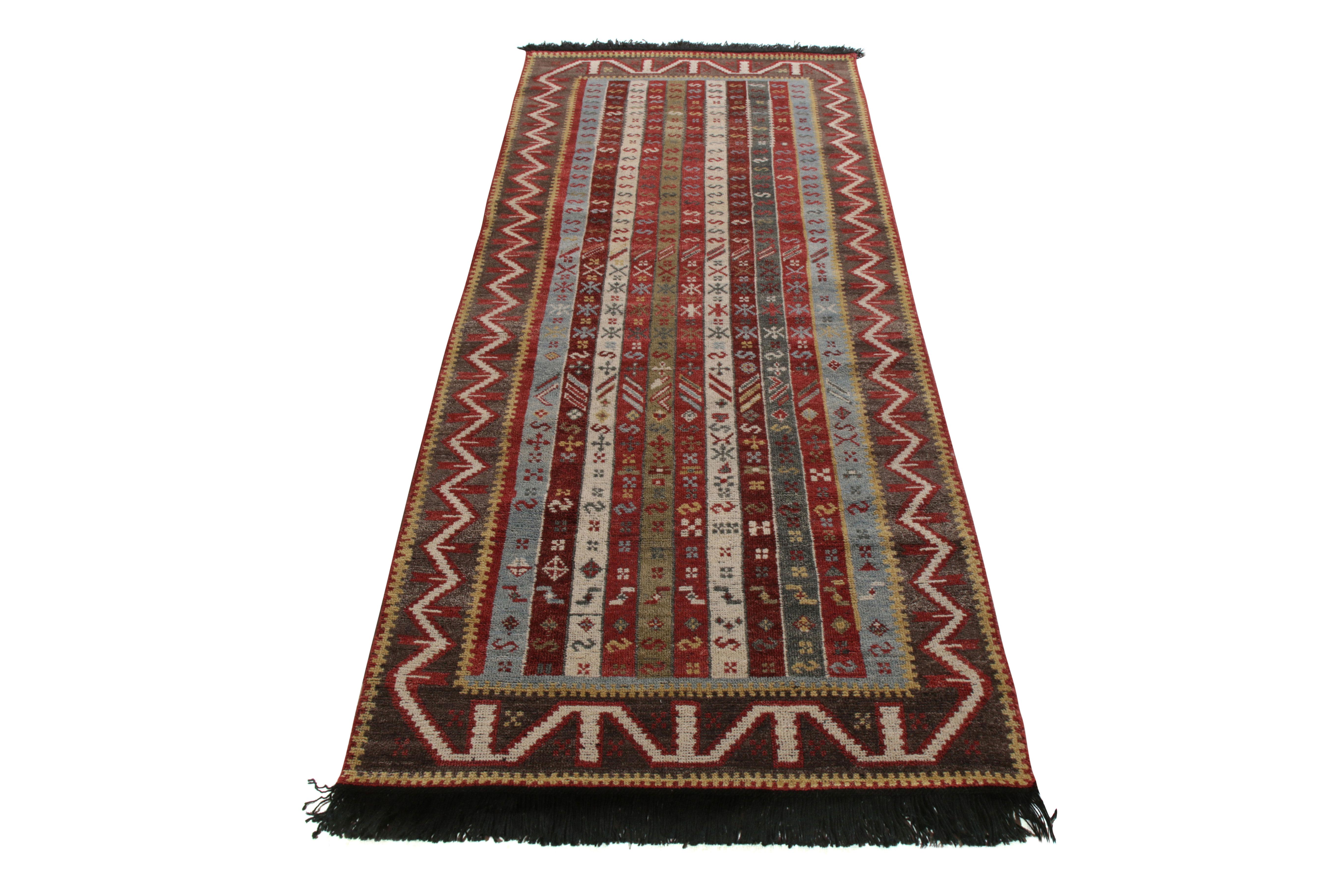 A 3 x 8 runner inspired by celebrated tribal rug styles, from Rug & Kilim’s Burano Collection. Hand knotted in notably soft Ghazni wool, enjoying red and blue with rich and lively accents in stripes and varied motifs. The intriguing take on