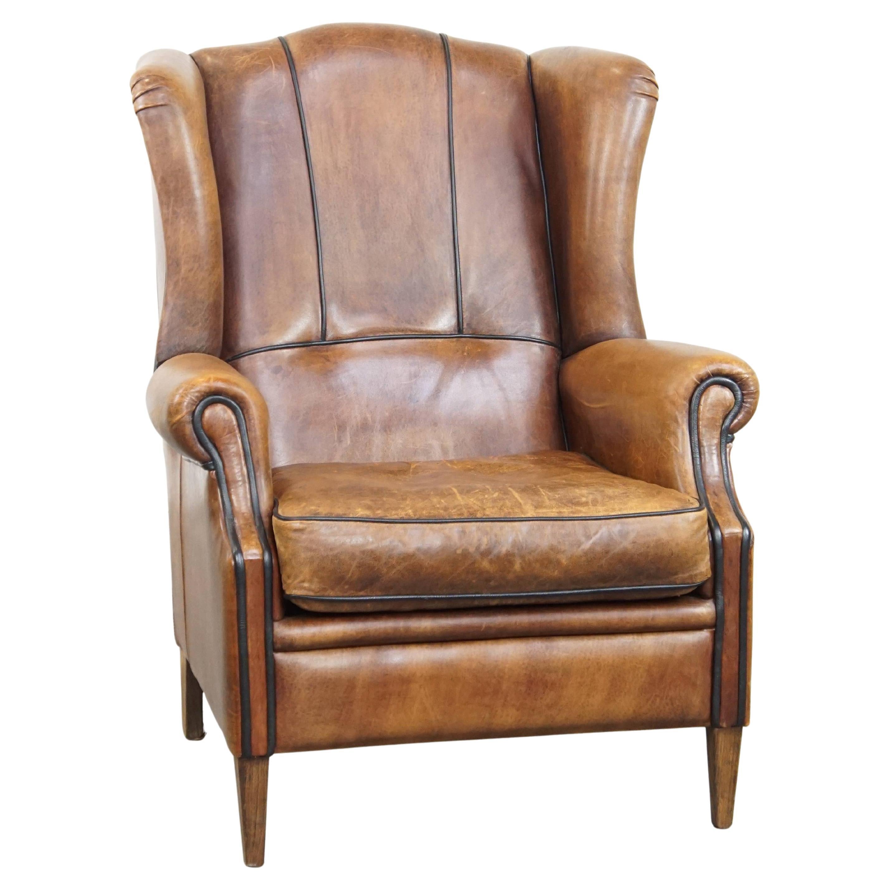 Rugged and comfortable sheepskin leather wingback chair with charming details