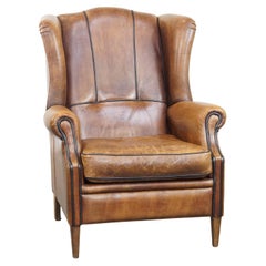 Rugged and comfortable sheepskin leather wingback chair with charming details