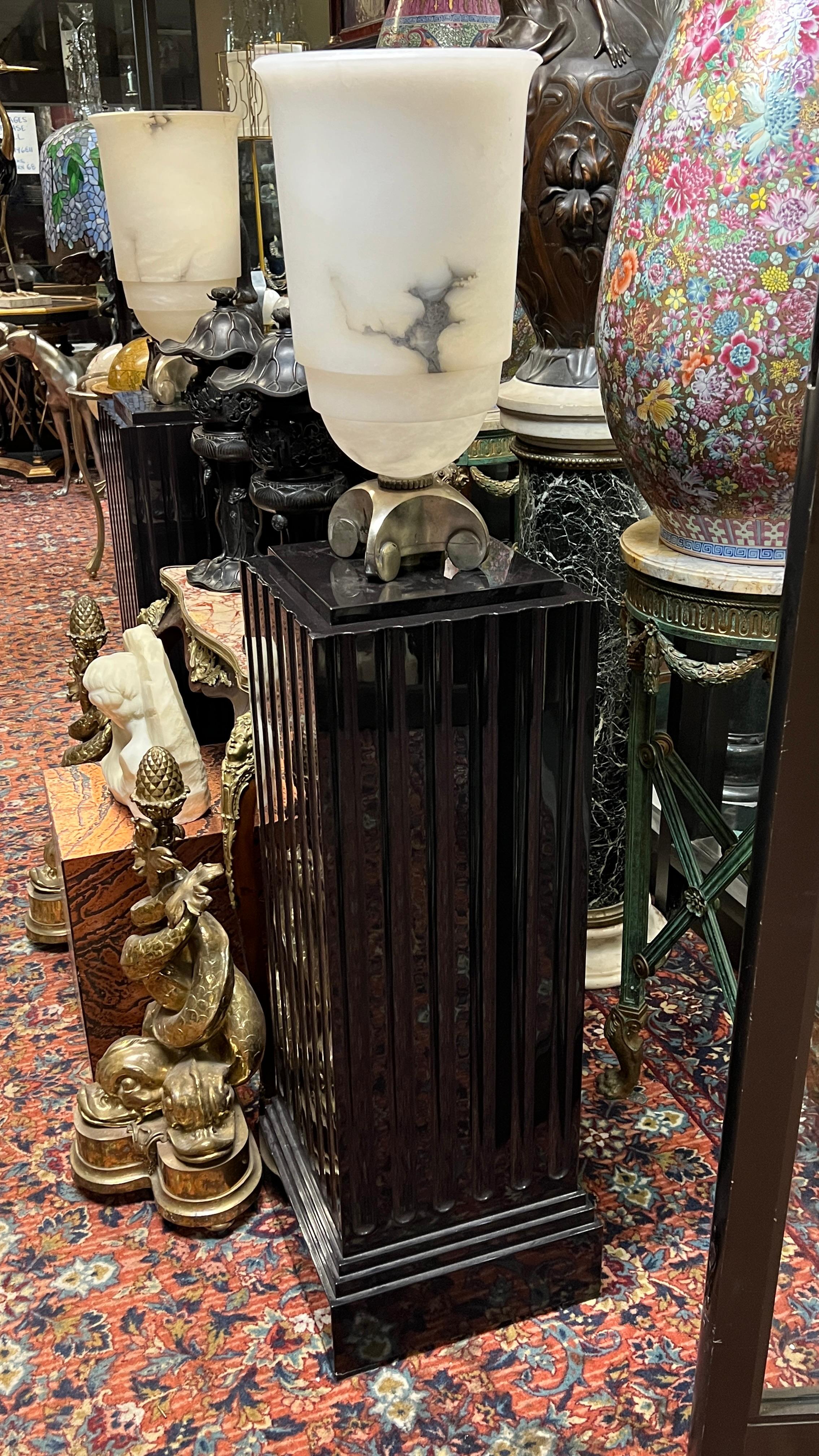 Pair of torchiere floor lamps featuring Art Deco period alabaster urns with lights after the original design by  Emile Jacques Ruhlmann (French, 1879–1933), entitled Urne Lumineuse (Luminous Urn) for the Ile-de-France ocean liner in 1927, mounted on