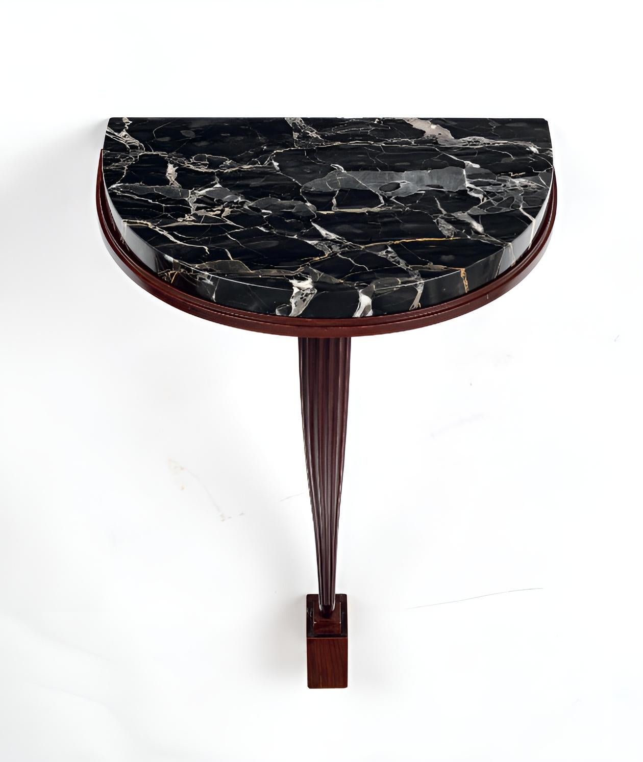 Console table known as 'Consolette’ in mahogany with a black marble top and elegantly curved leg. Referenced in the Ruhlmann Archives under nos. 4002 NR t 1034 AR. The model exhibited at the Salon des Artistes décorateurs in Paris, 1924. Stamped